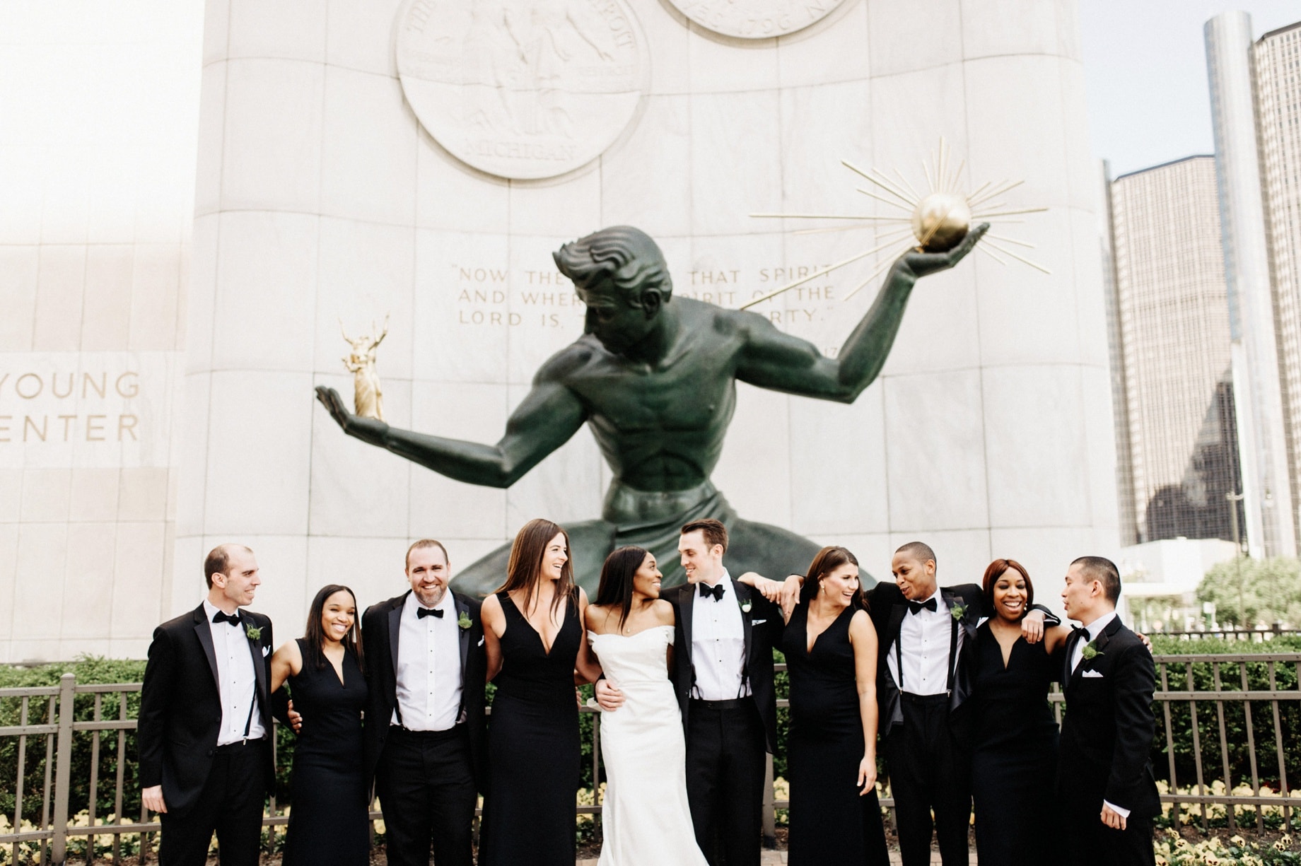 wedding party in front of the spirit of Detroit sculpture