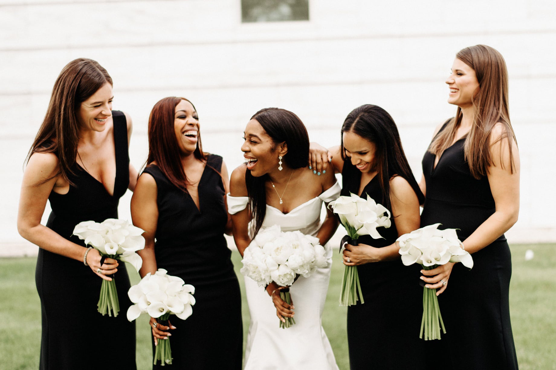 bride with bridesmaids in black gowns