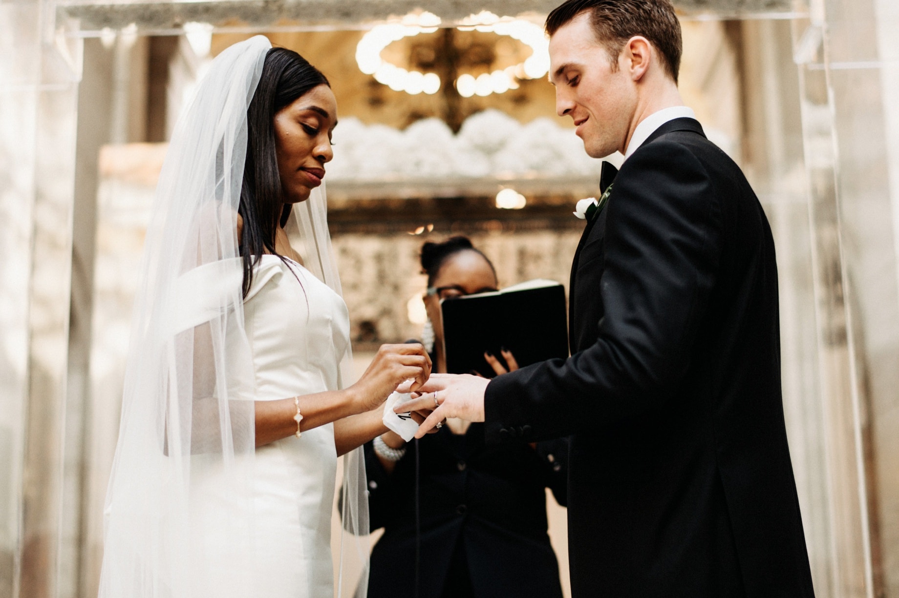 bride and groom exchanging rings