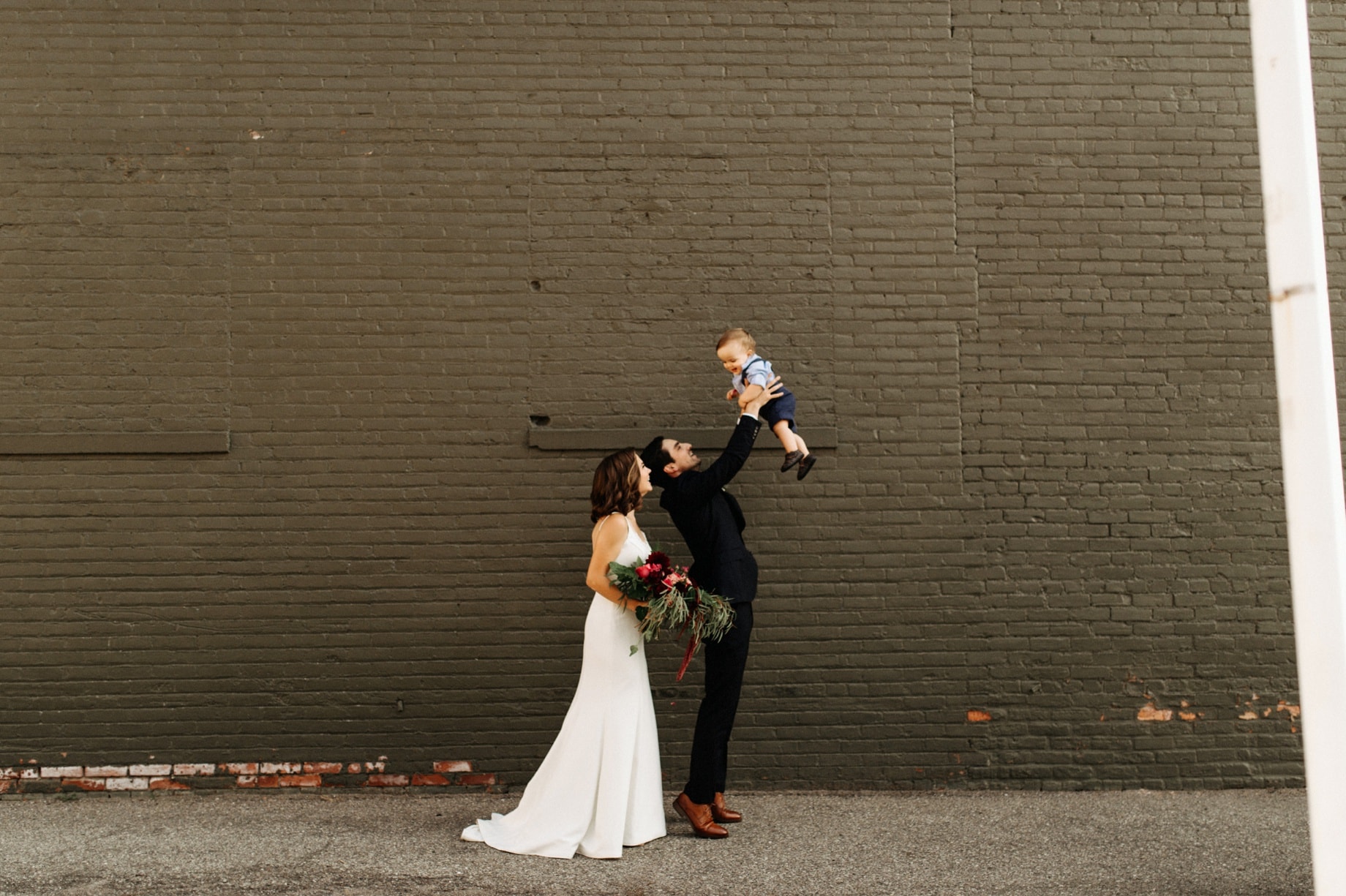 bride and groom with their son