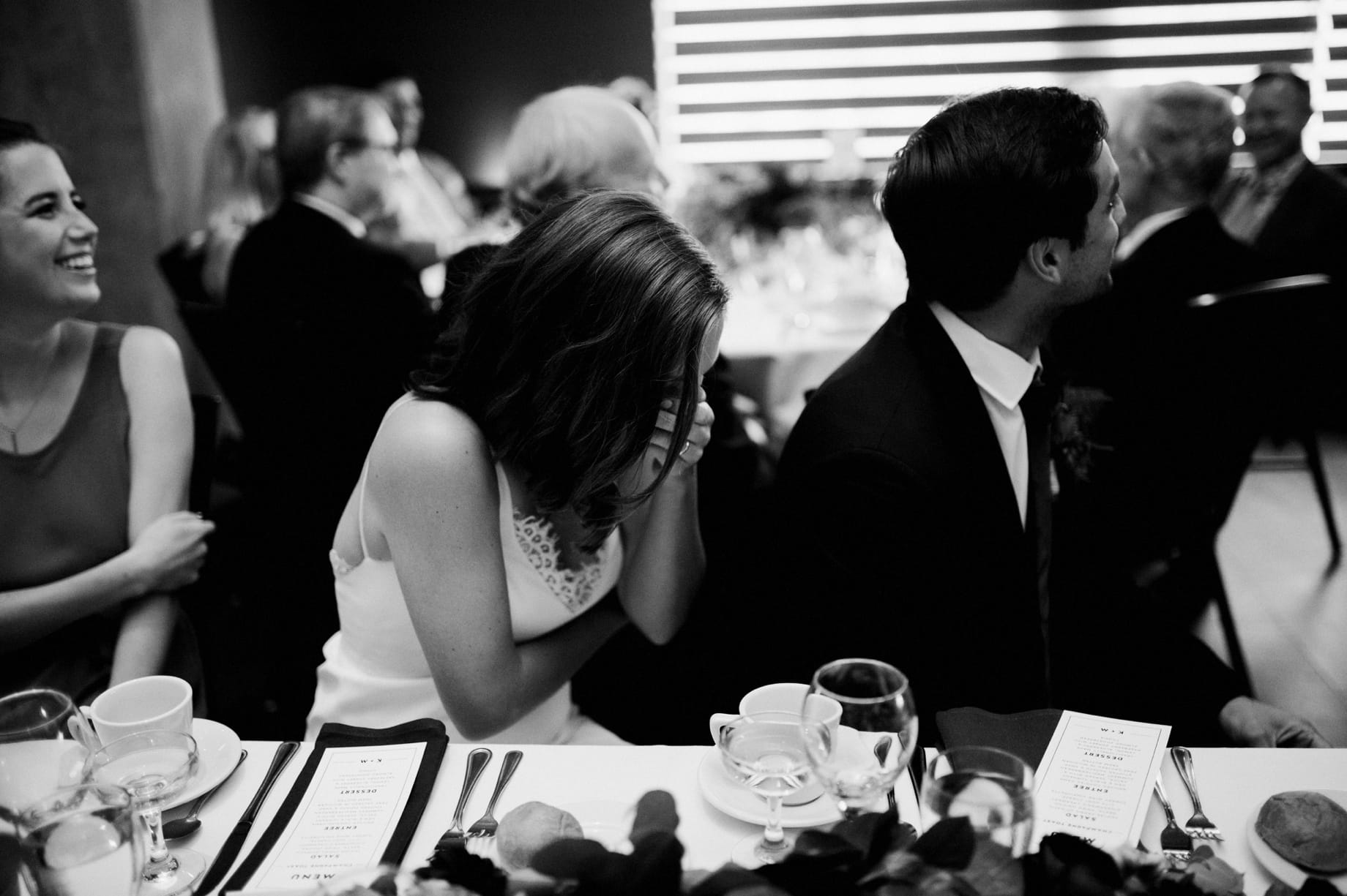 bride laughs during her fathers toast at her Ann Arbor Zingermans Greyline wedding