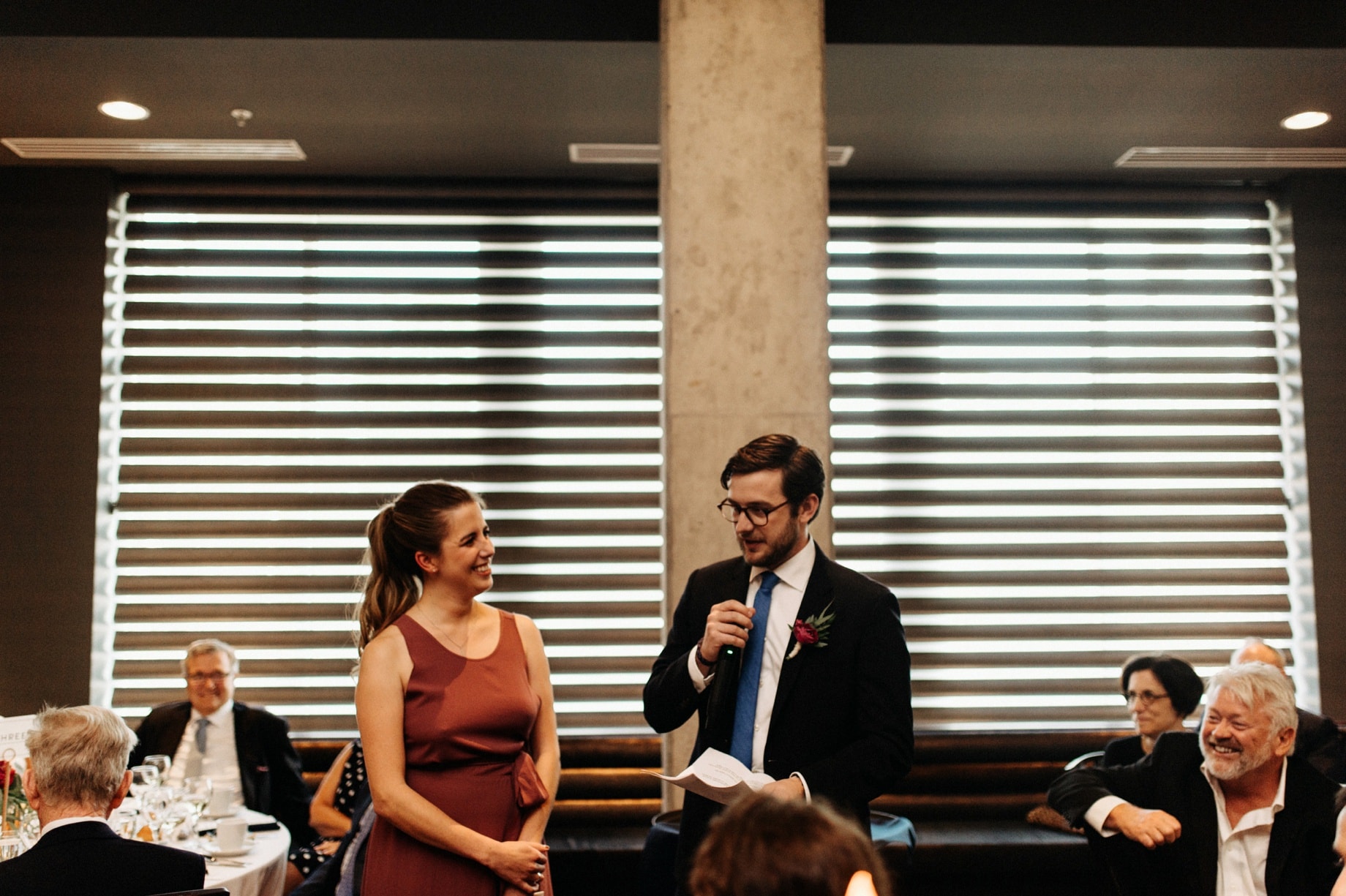 best man and maid of honor toasting the bride