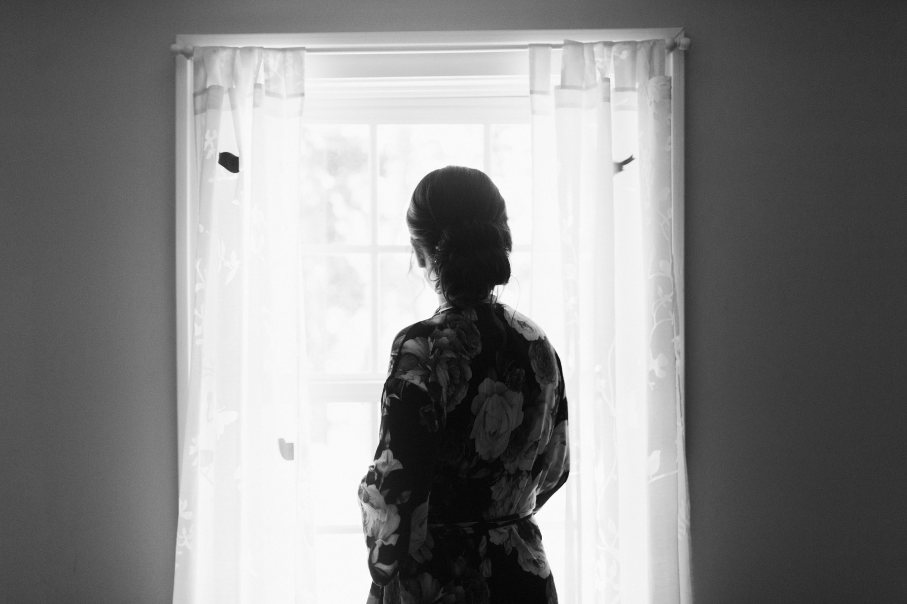 Bride looking out the window over cornman farms