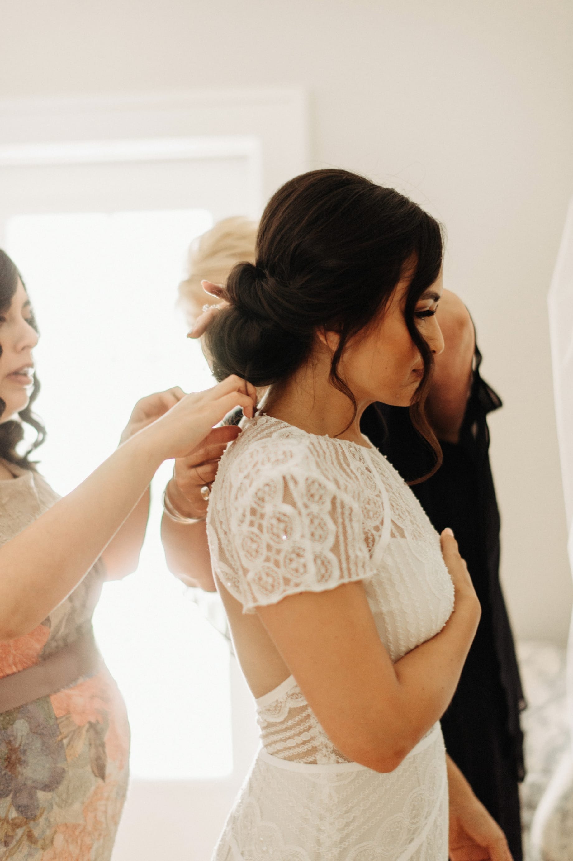 bride being helped into her bhldn dress