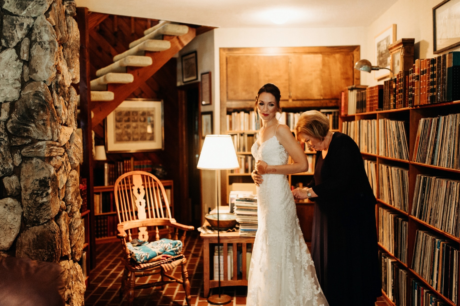 mother helps daughter into dress surrounded by vinyl records