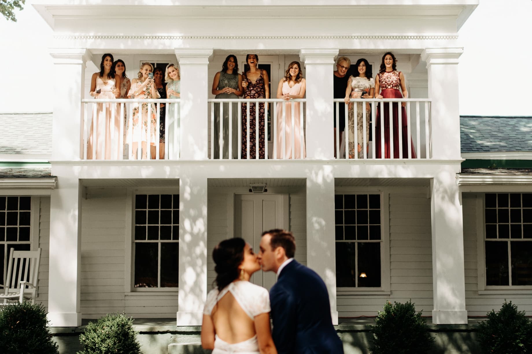 bridesmaids cheering for bride and groom