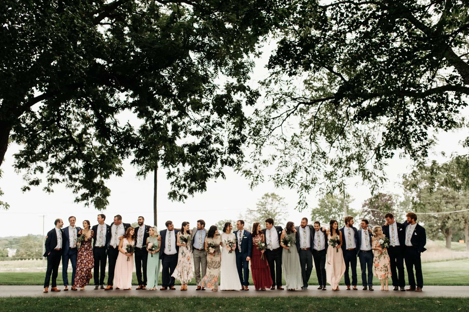 bridesmaids in long pastel and floral dresses