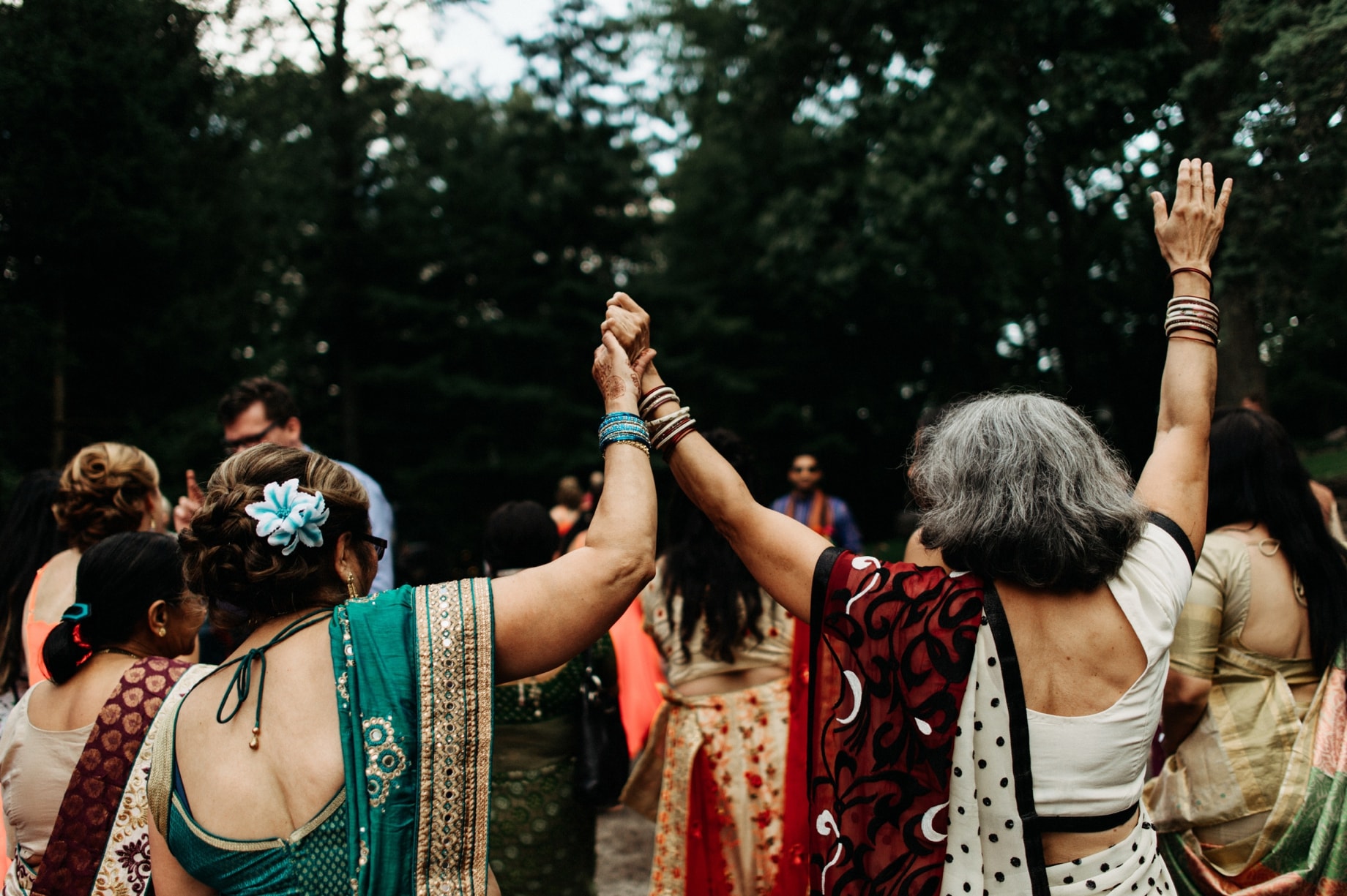 women dancing in saris during a barat