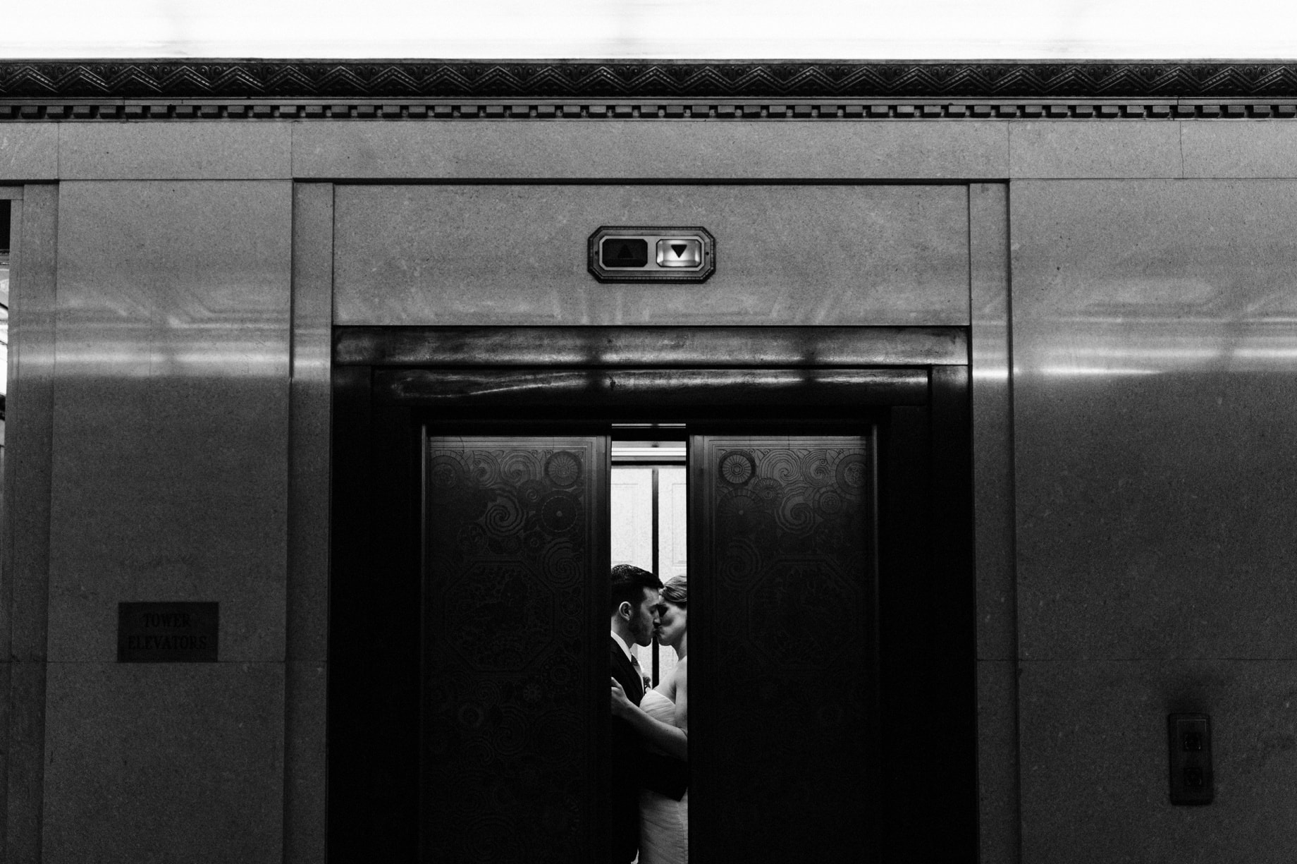 bride and groom in an elevatior at the fisher building in detroit