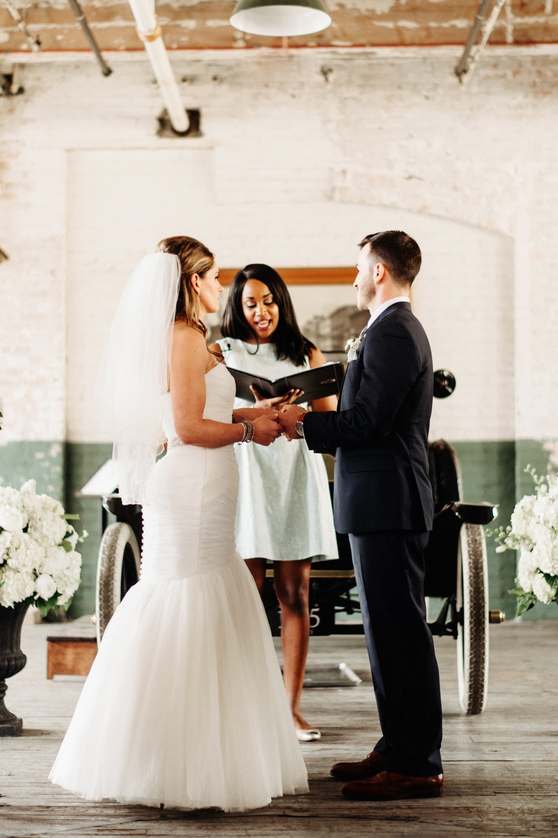 bride and groom during wedding ceremony at ford piquette plant