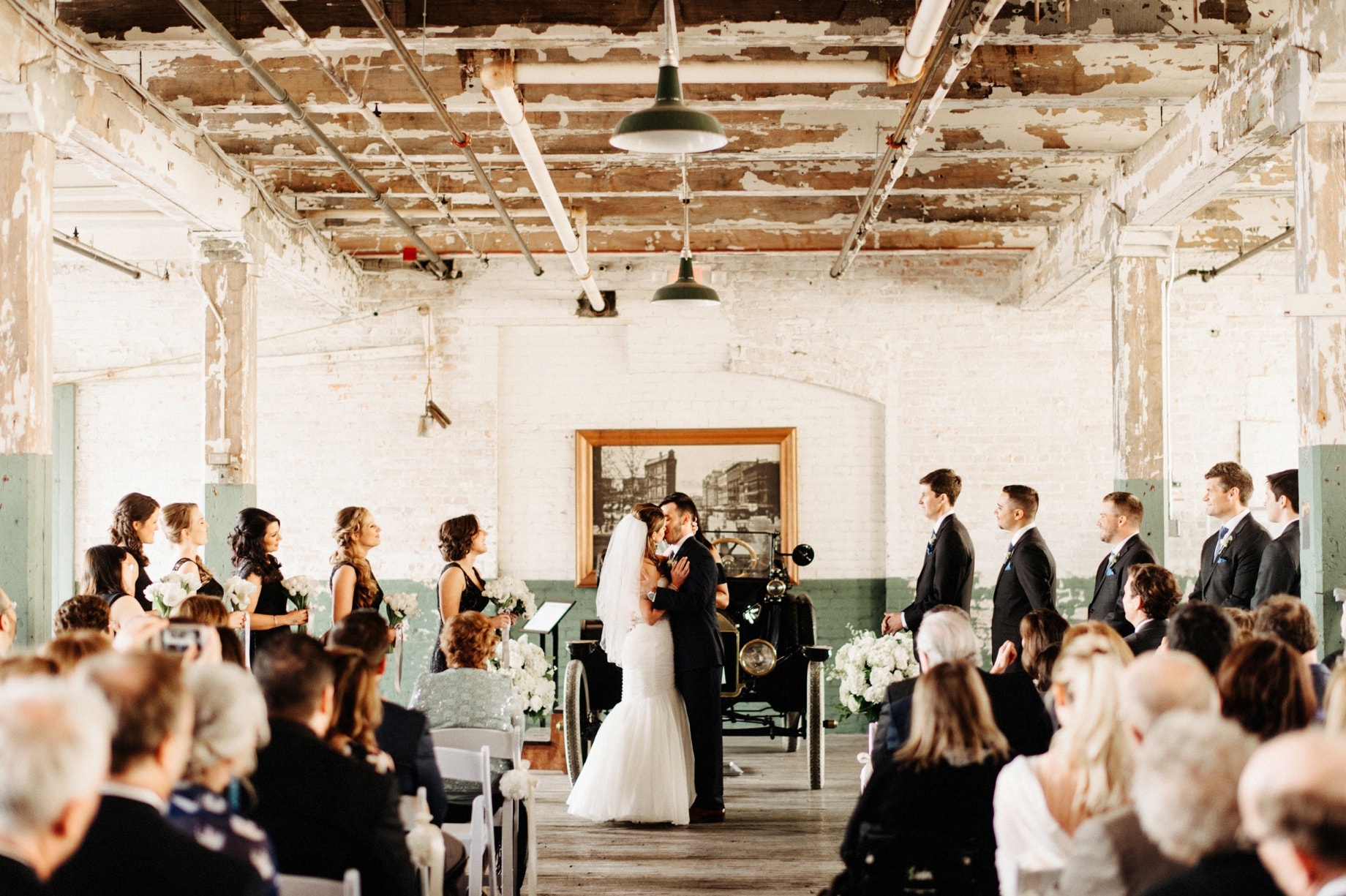 bride and groom share first kiss during their detroit wedding