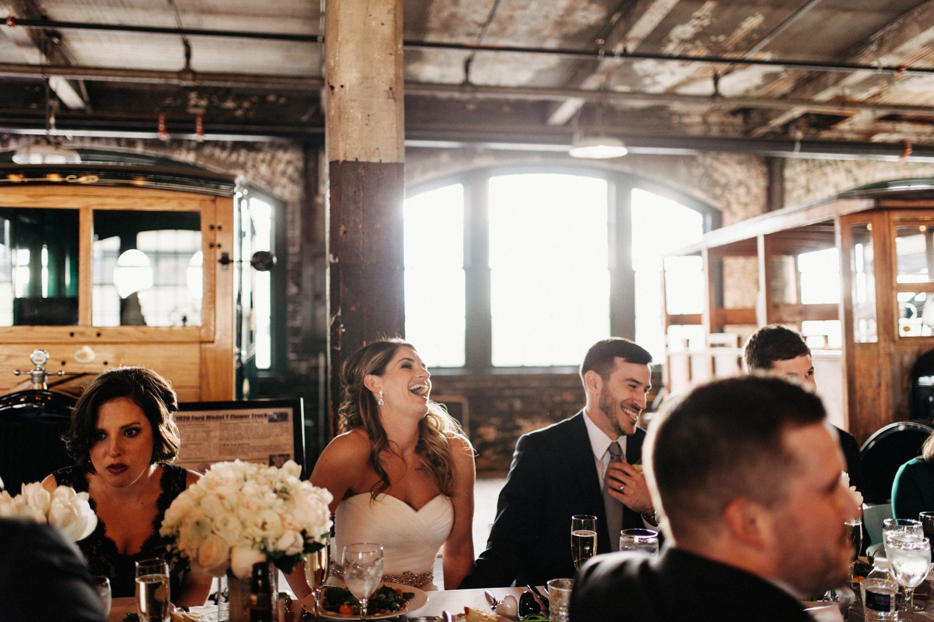bride and groom laughing at toasts by Detroit Wedding photographer Heather Jowett