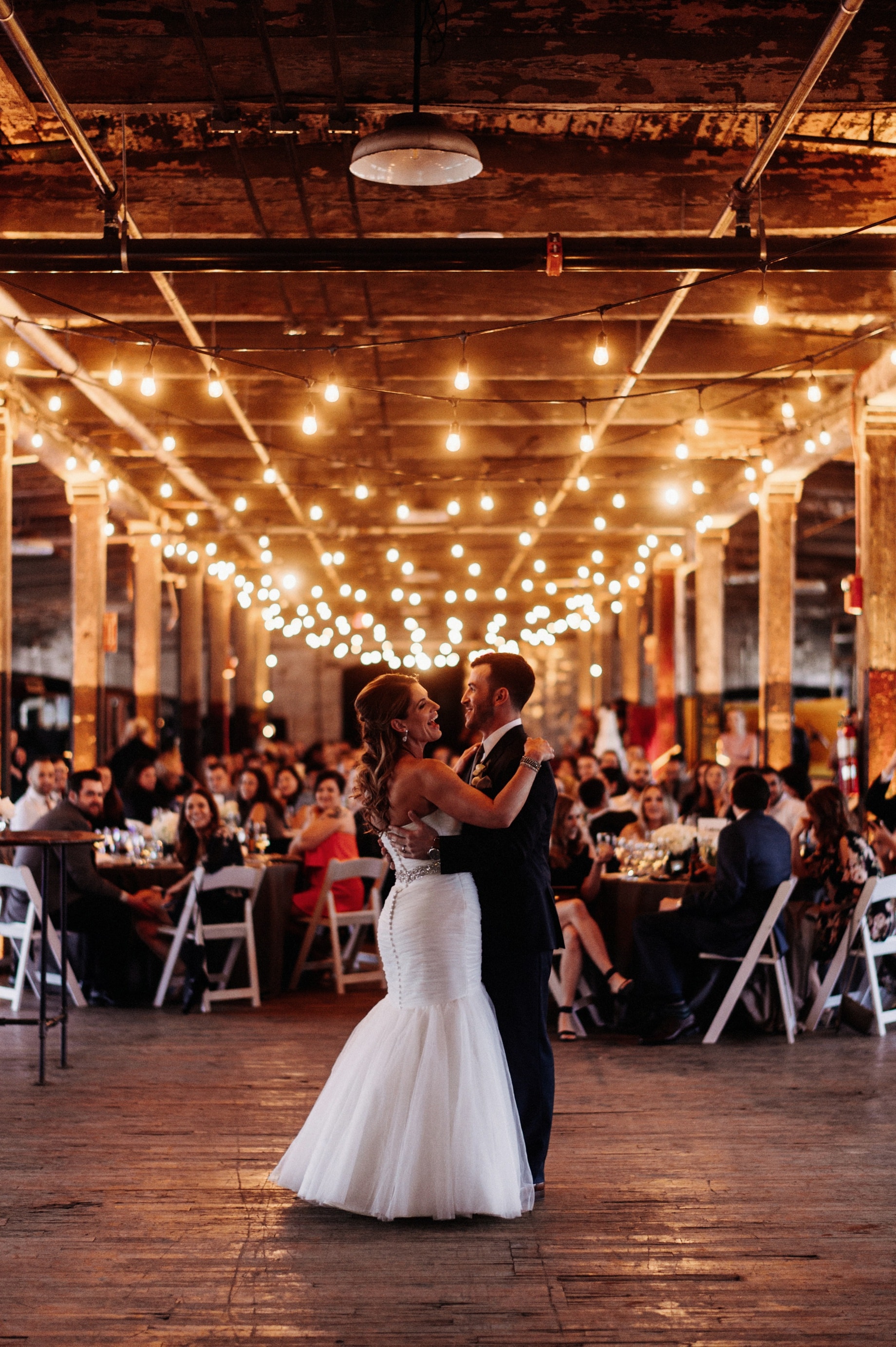 bride and groom share first dance at the ford piquette plant by Detroit Wedding photographer Heather Jowett