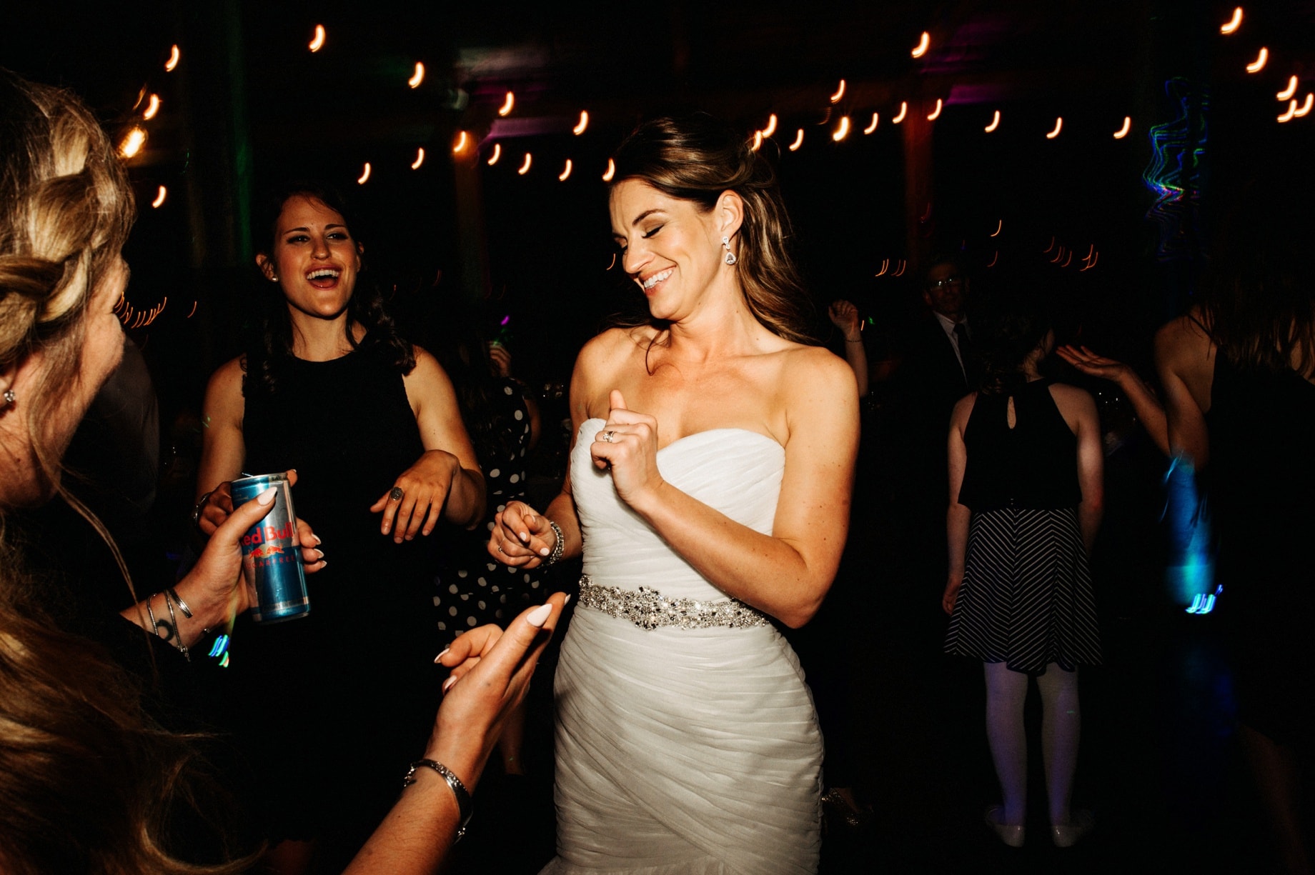 bride dancing with friends by Detroit Wedding photographer Heather Jowett