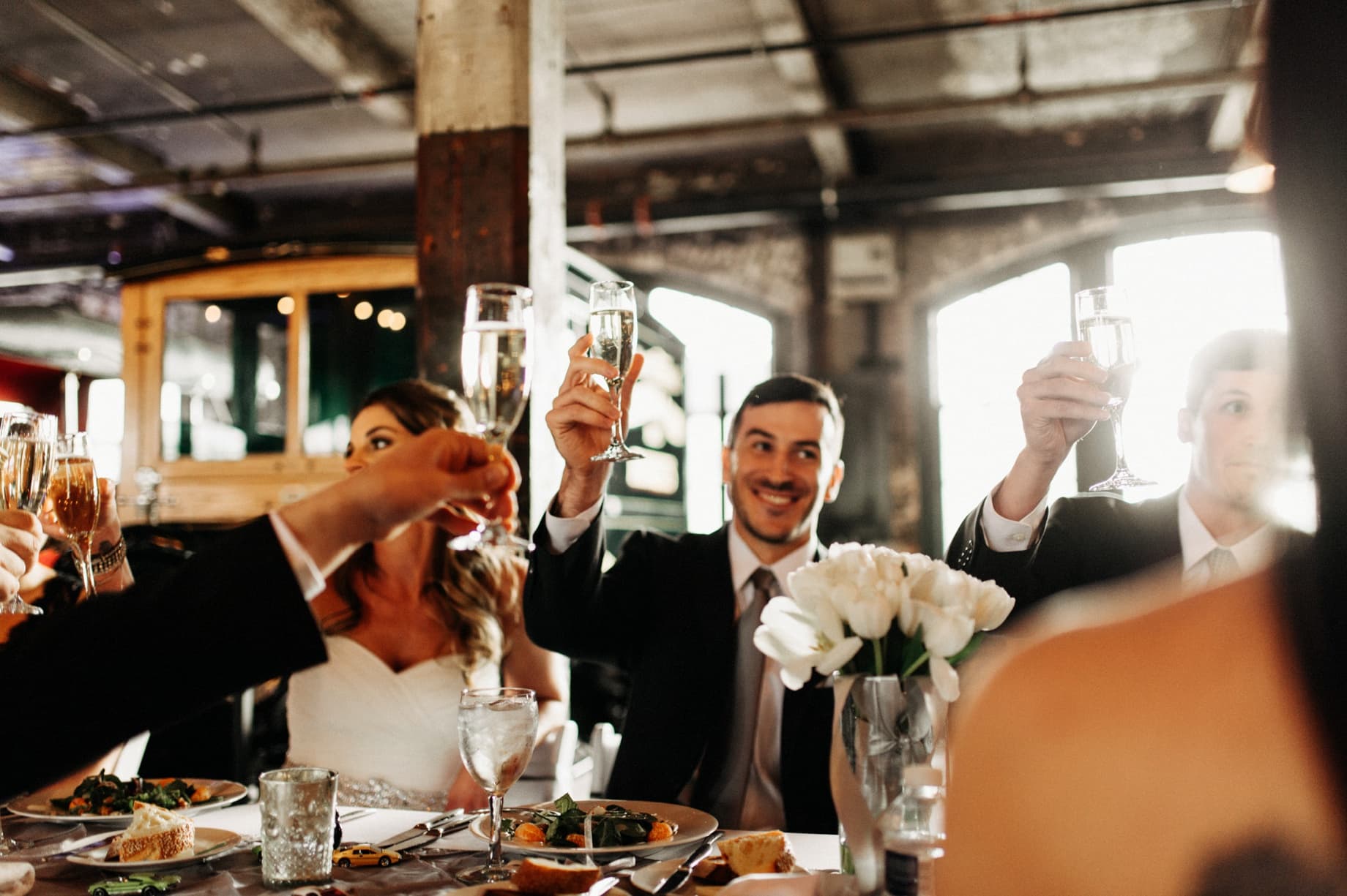 bride and groom raising their glasses