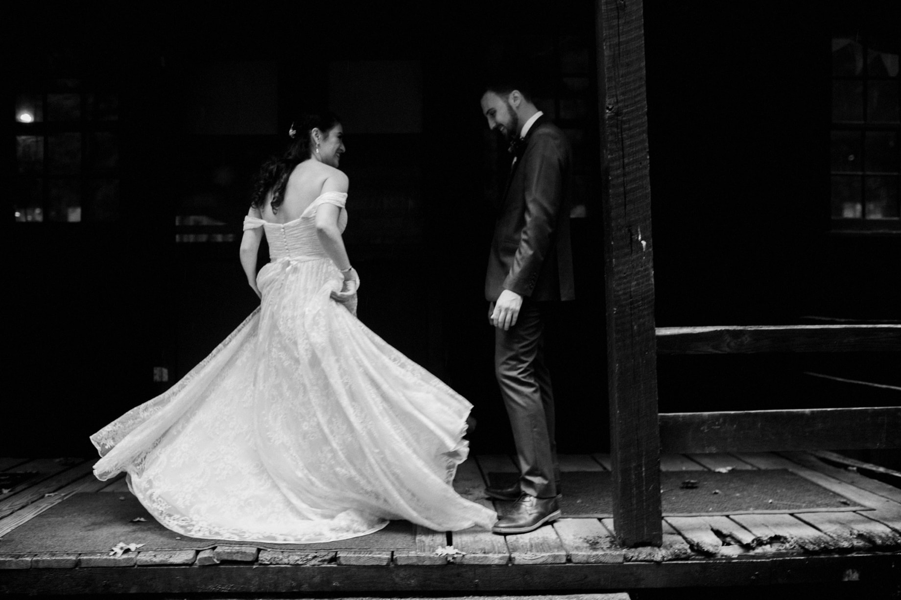 bride showing off her dress to her groom