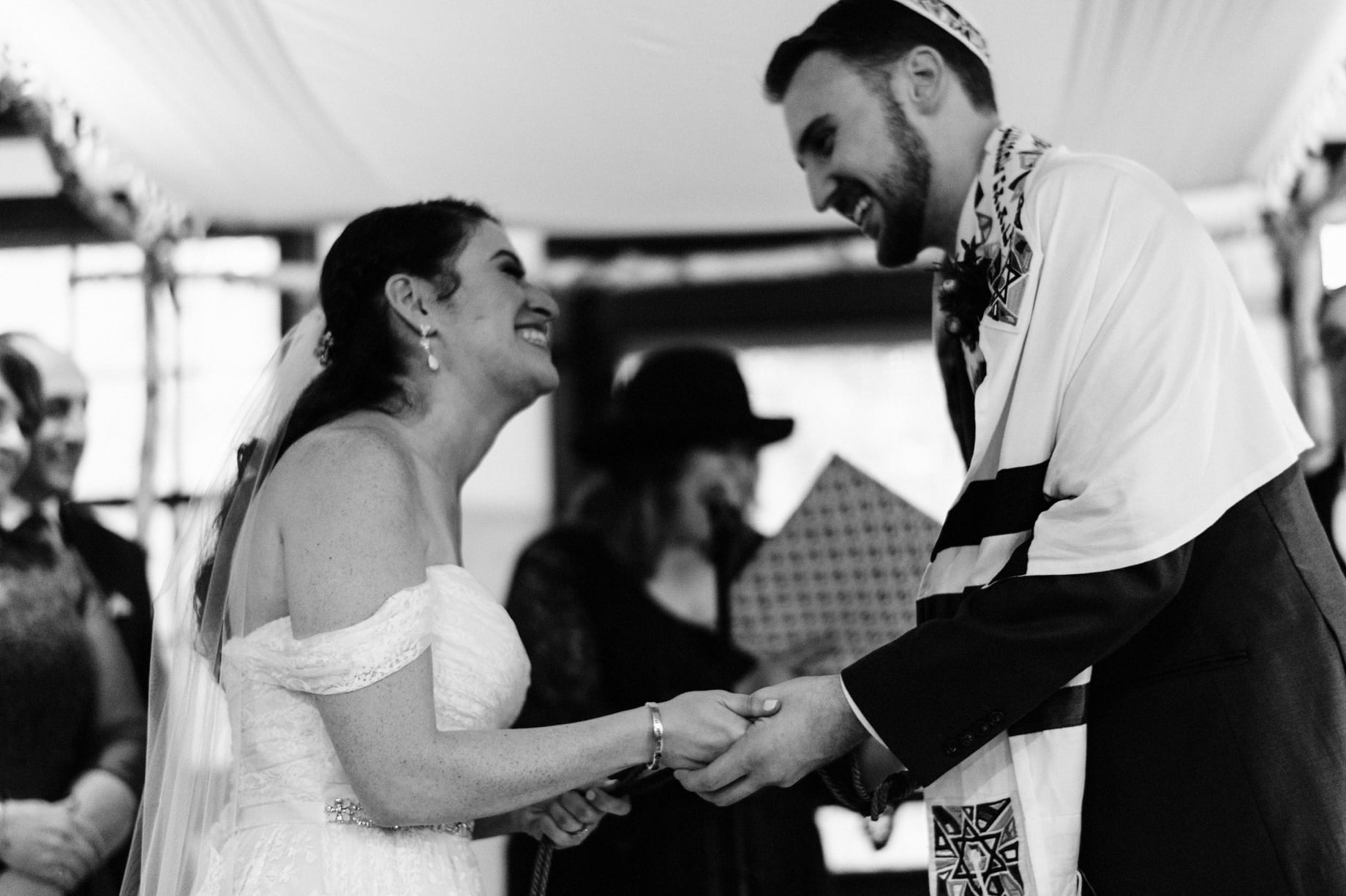 bride and groom laugh during their wedding ceremony