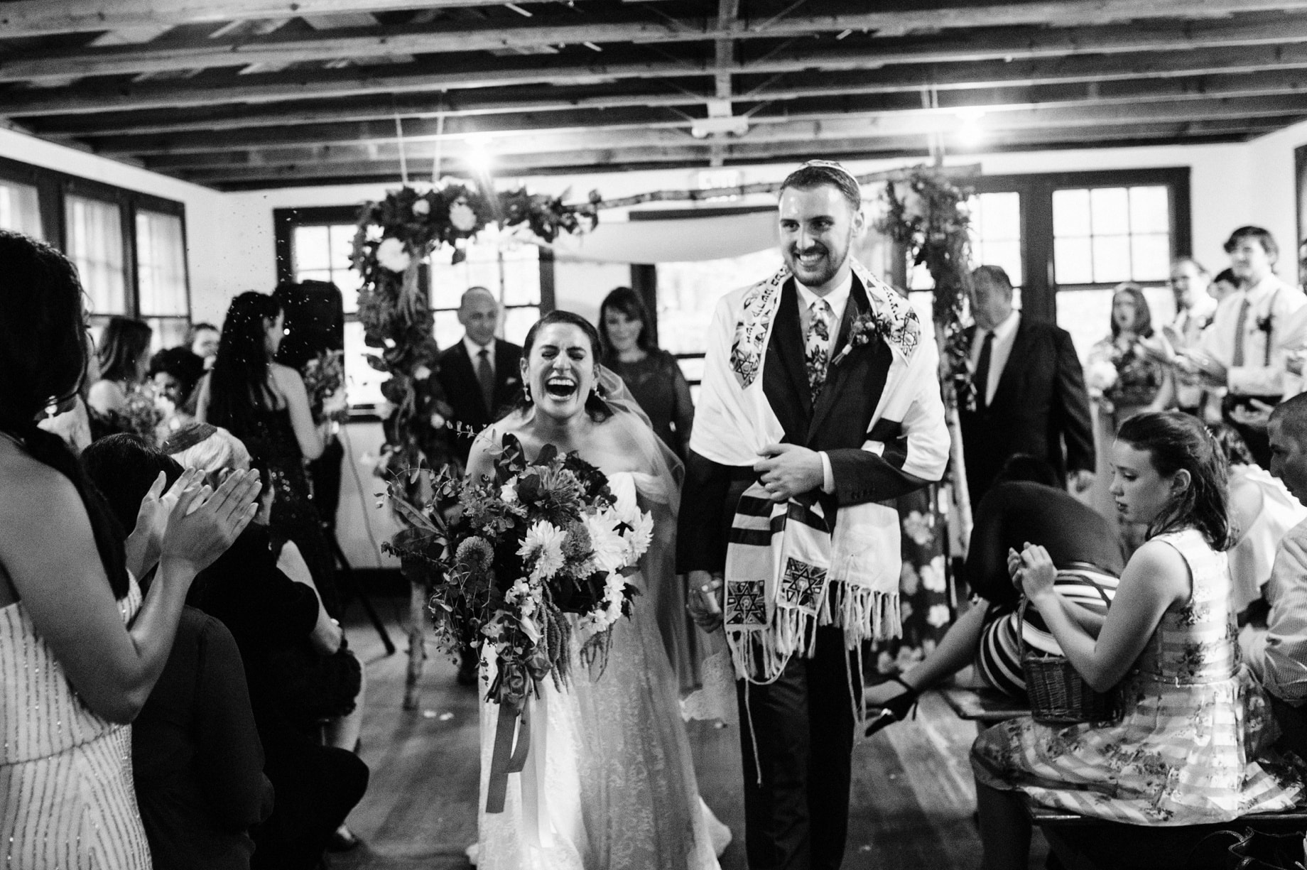 bride laughs as they leave their wedding ceremony