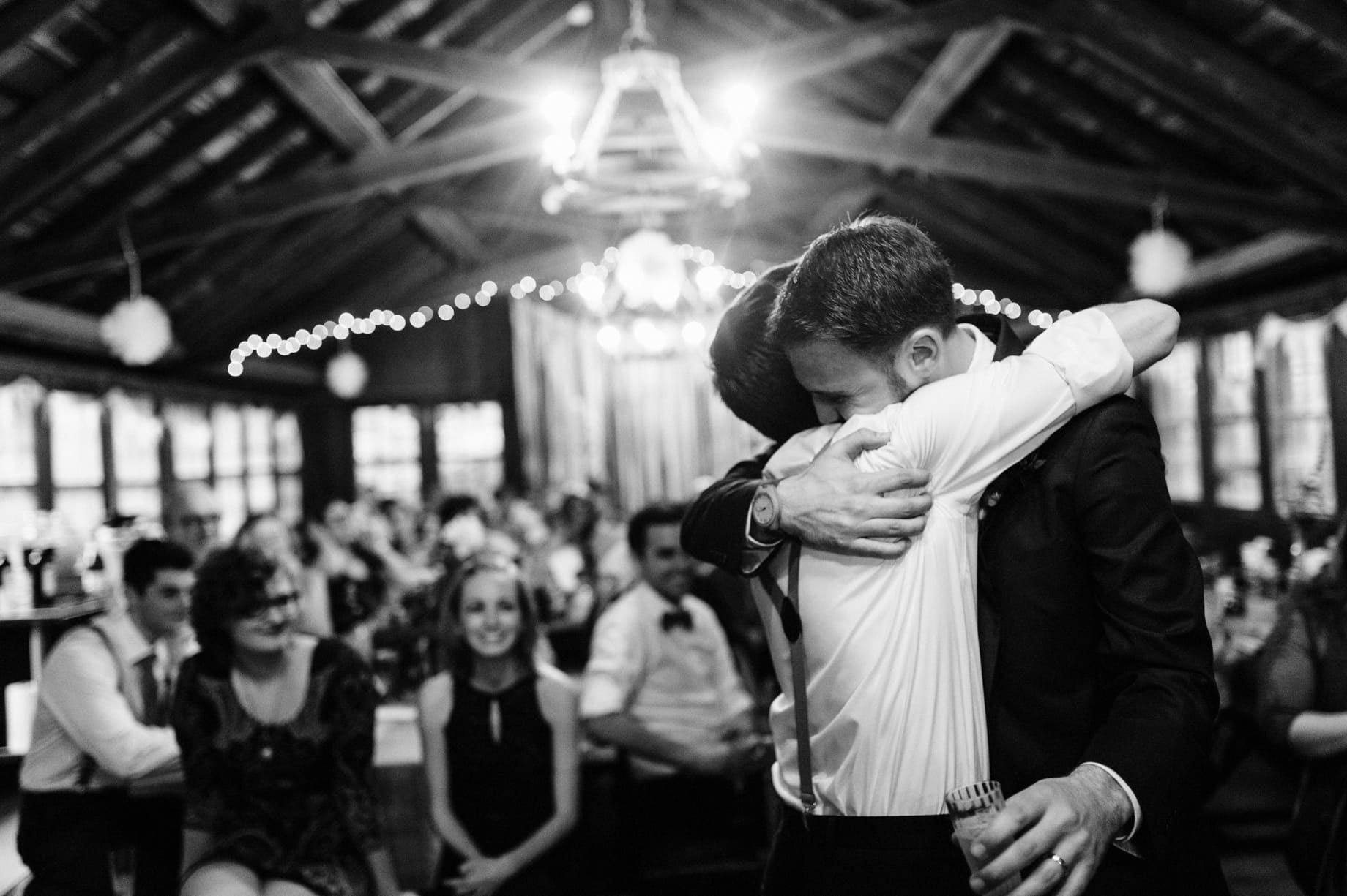 groom hugging best man