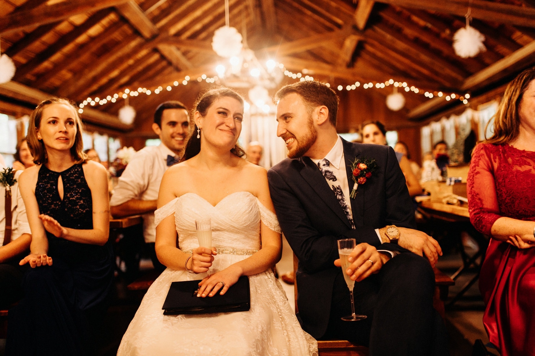 bride and groom listening to speeches