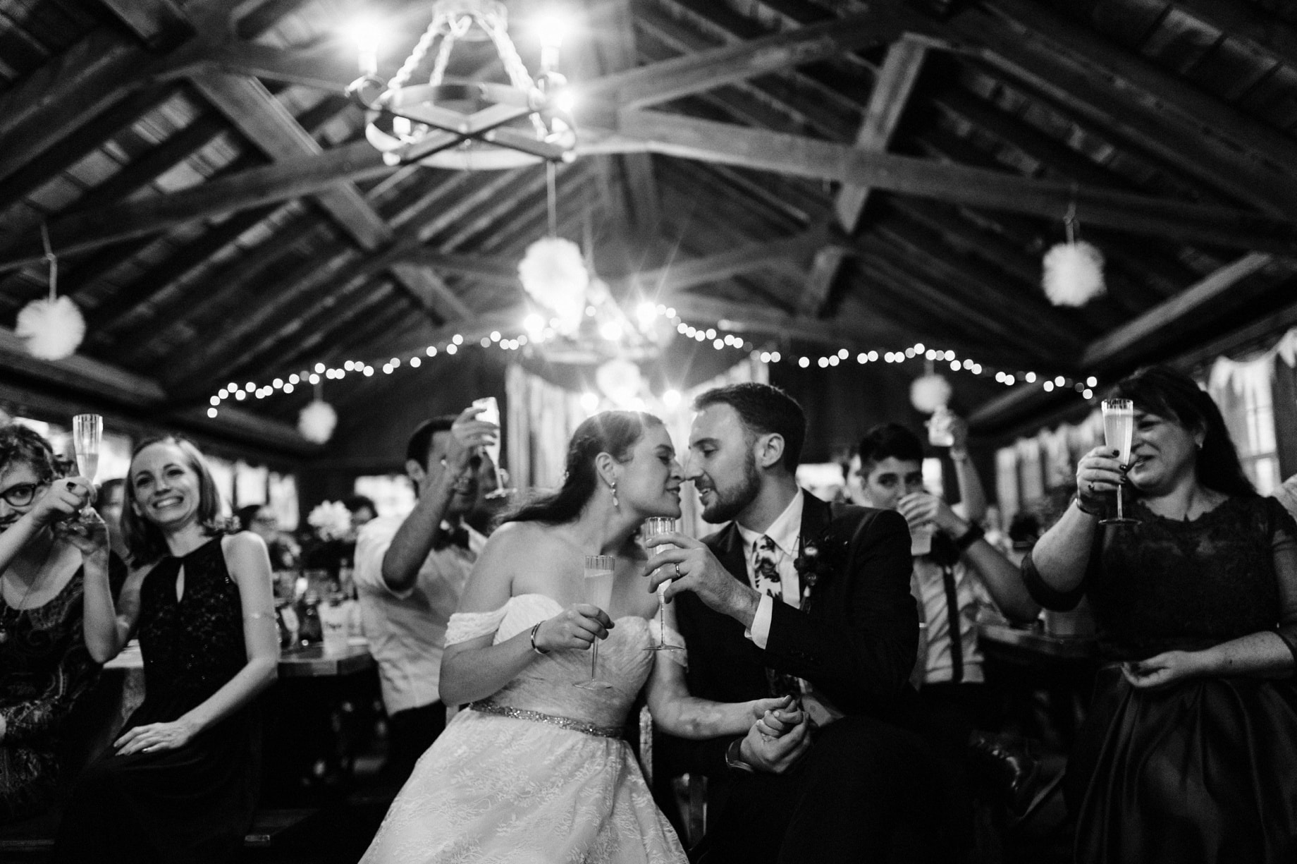 bride and groom raise their glasses