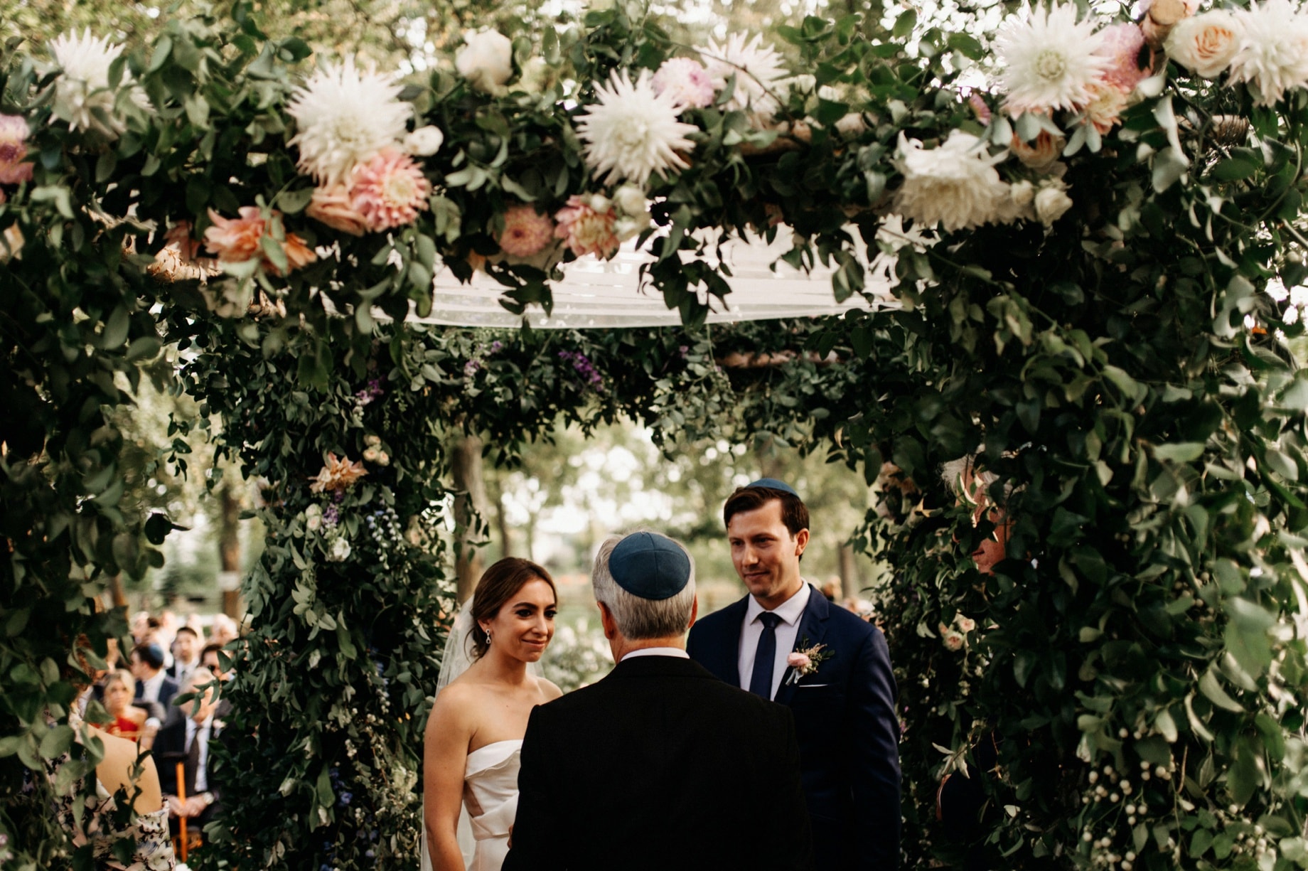 bride and groom under the huppah at cornman farms