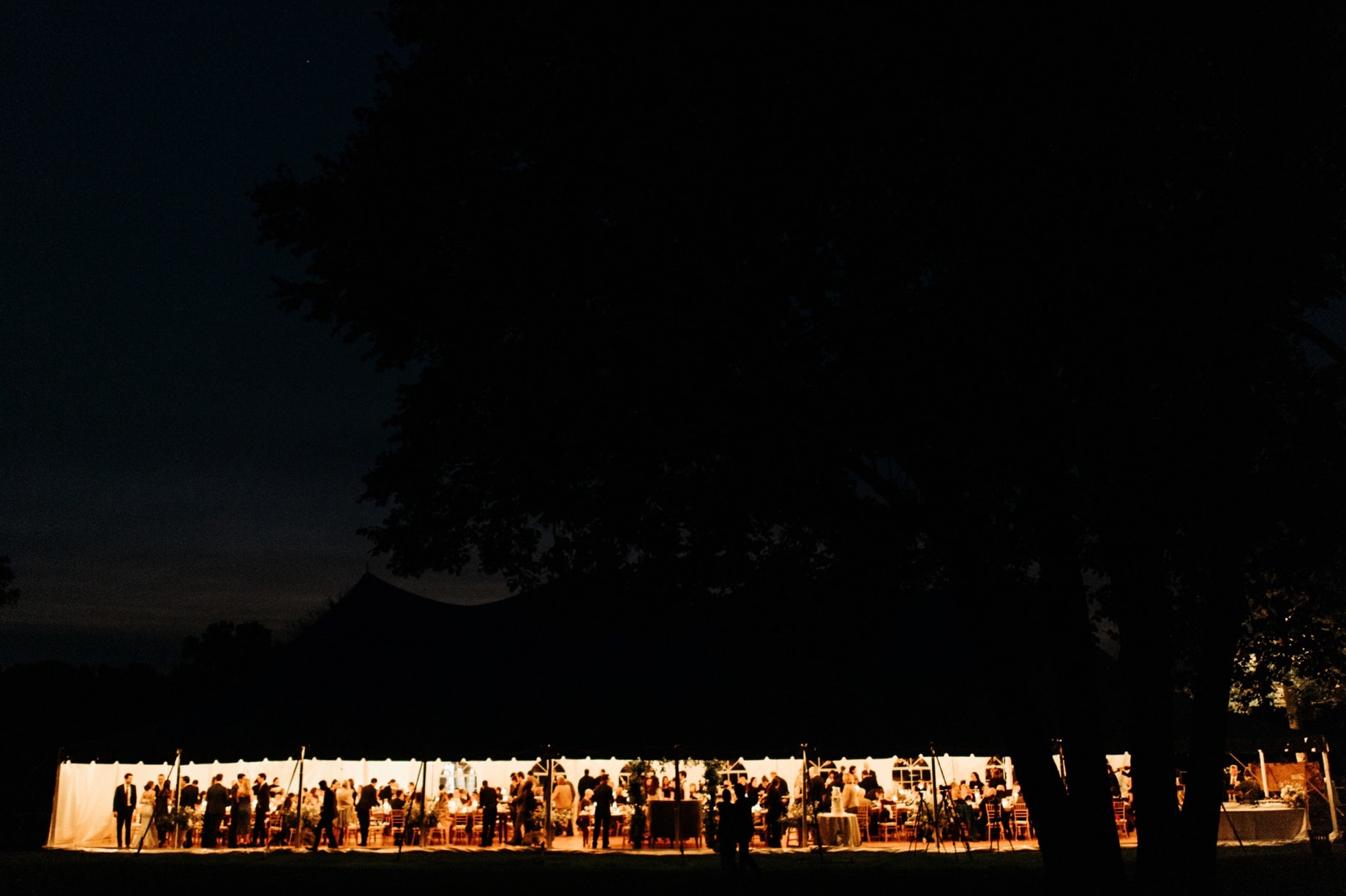 a night scene of the tent at cornman farms