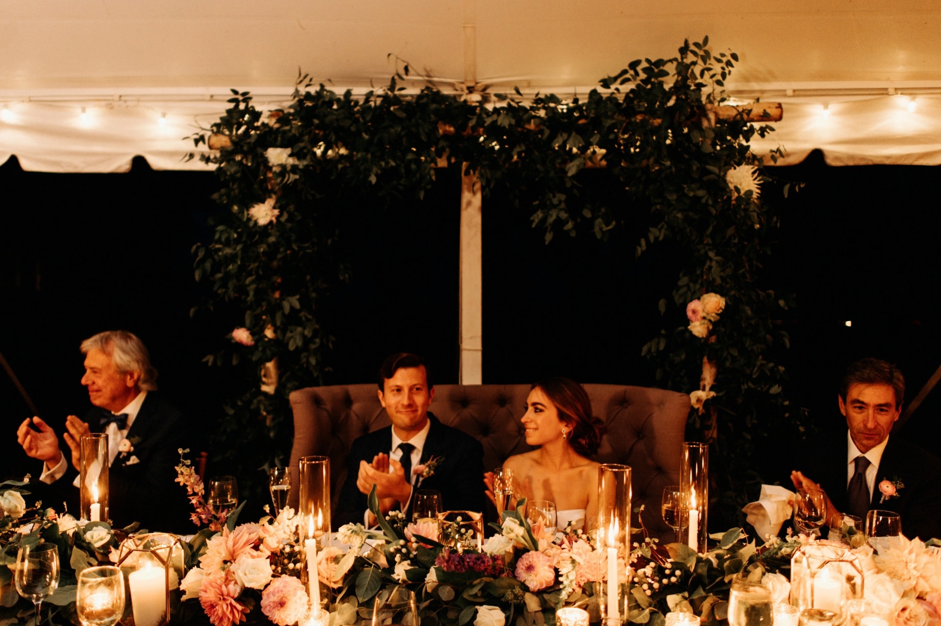 bride and groom listen to speeches