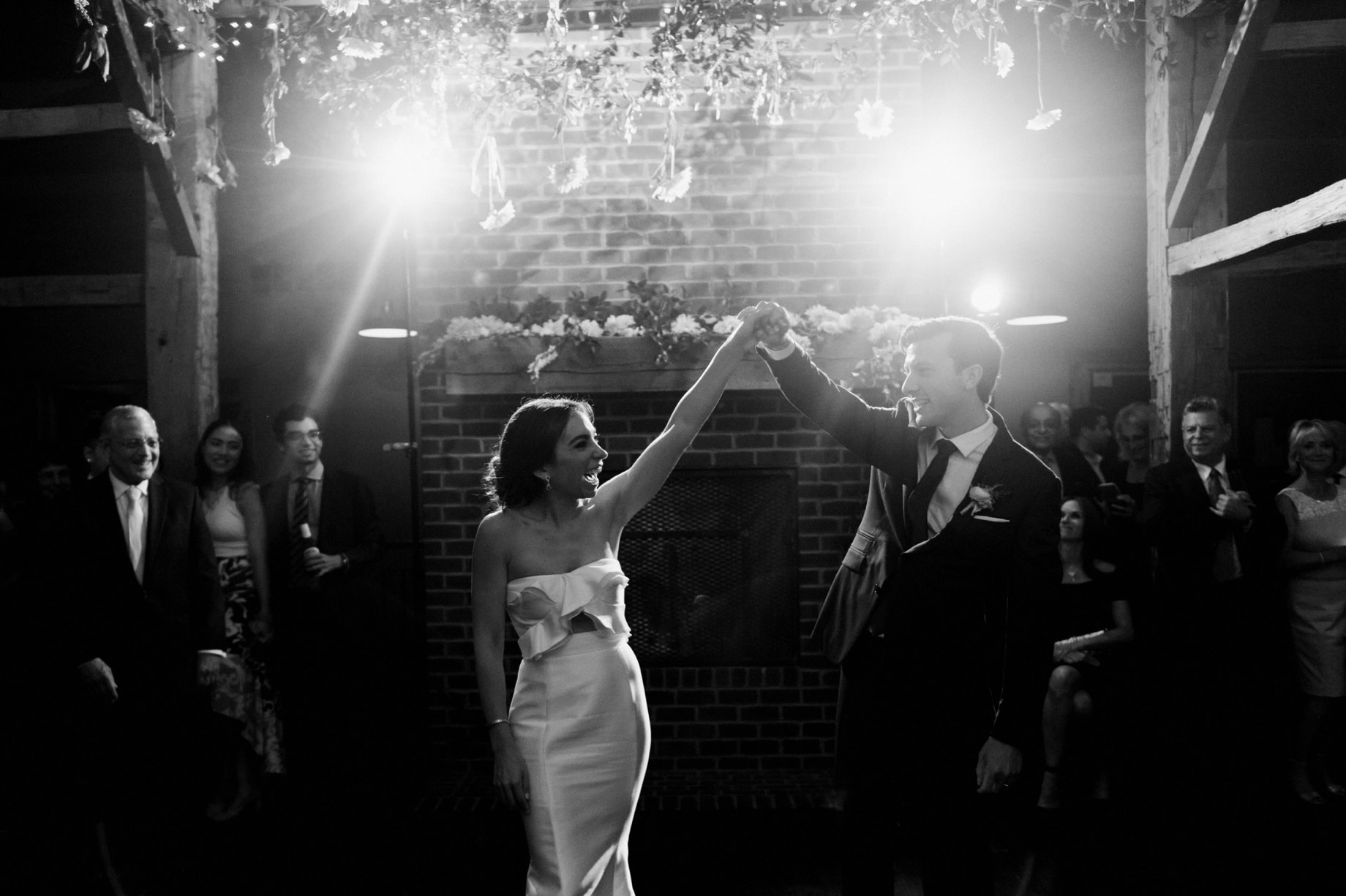 bride and groom share their first dance in the barn