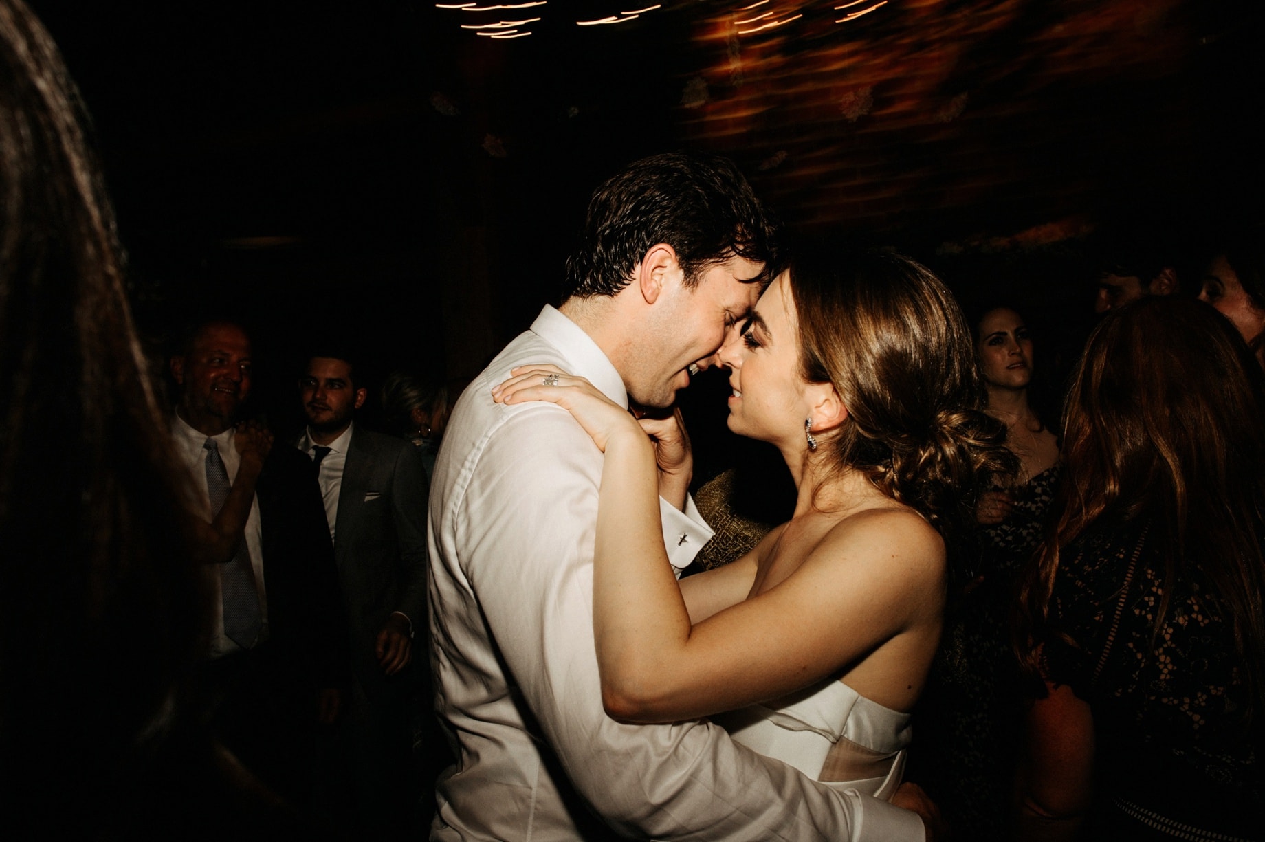bride and groom steal a kiss on the dance floor