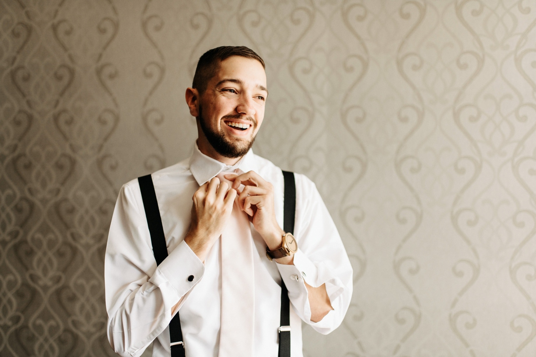 Groom getting read at the inn at st johns wedding by Detroit wedding photographer Heather Jowett