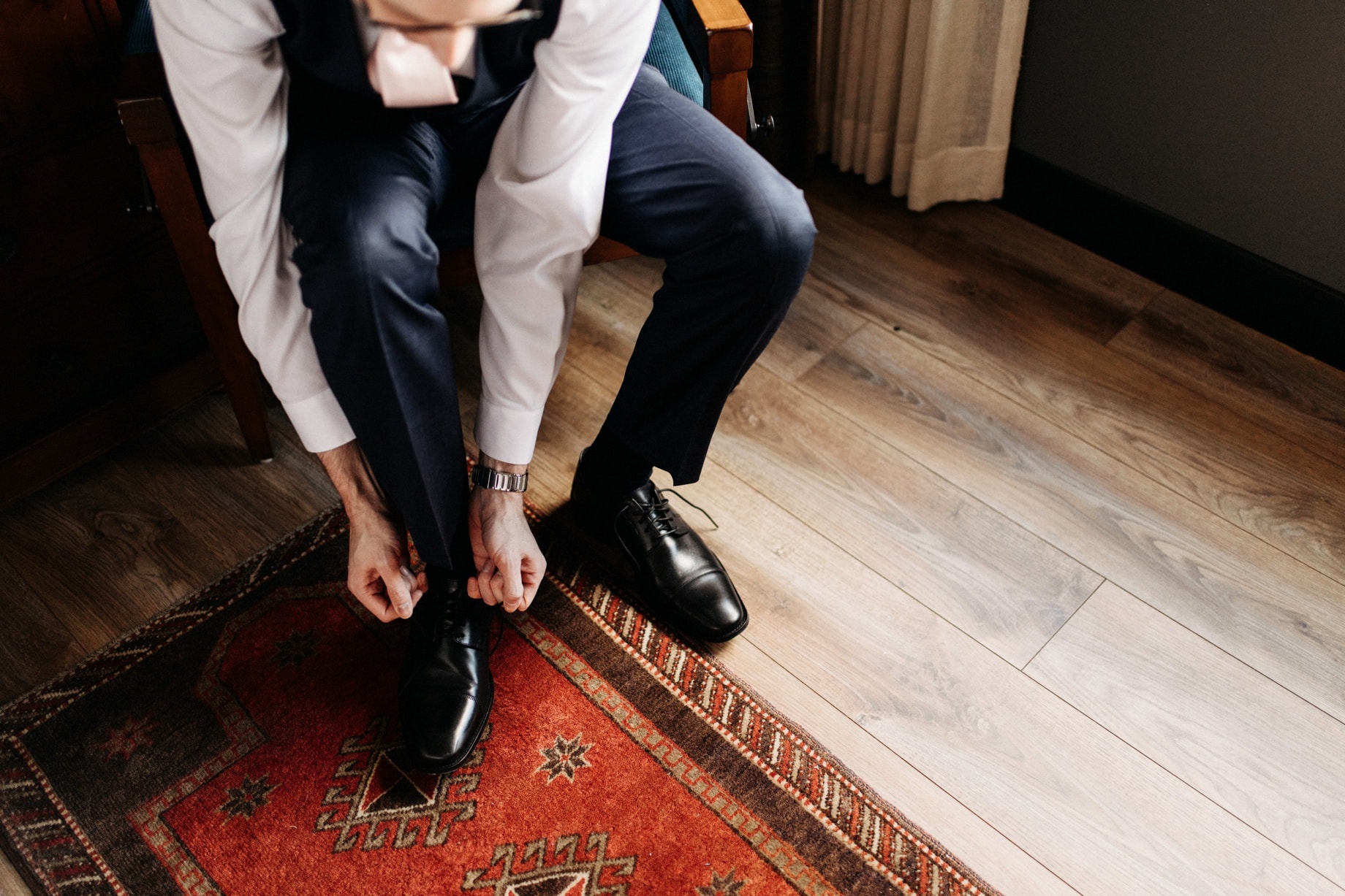 Groom putting on shoes