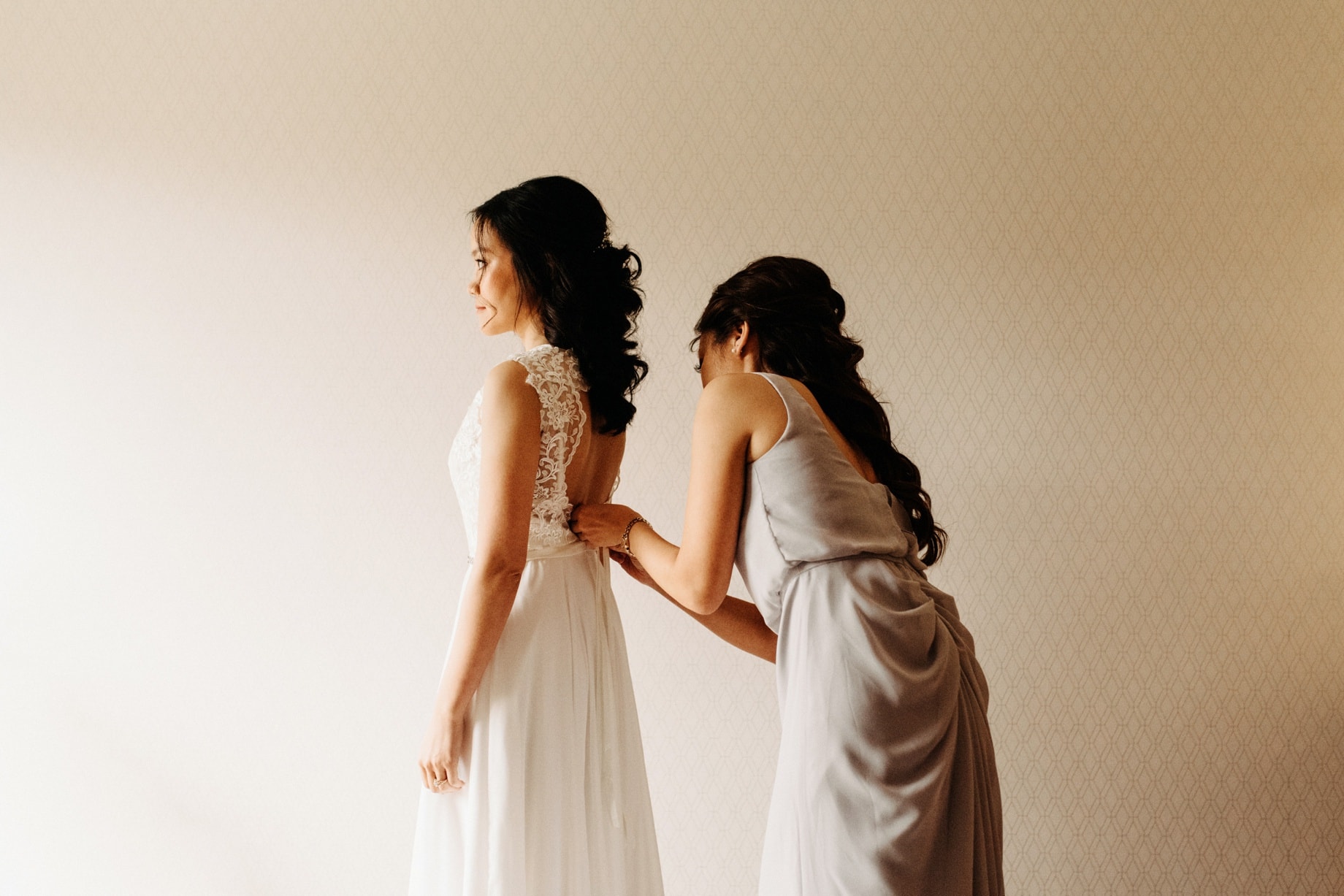 bride getting dressed before an Ann Arbor wedding