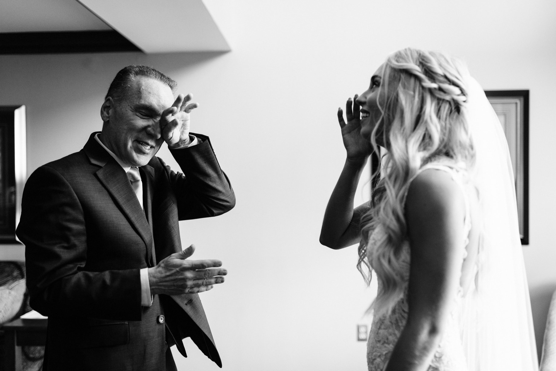 father of the bride cries upon seeing his daughter in her wedding dress by Detroit wedding photographer Heather Jowett
