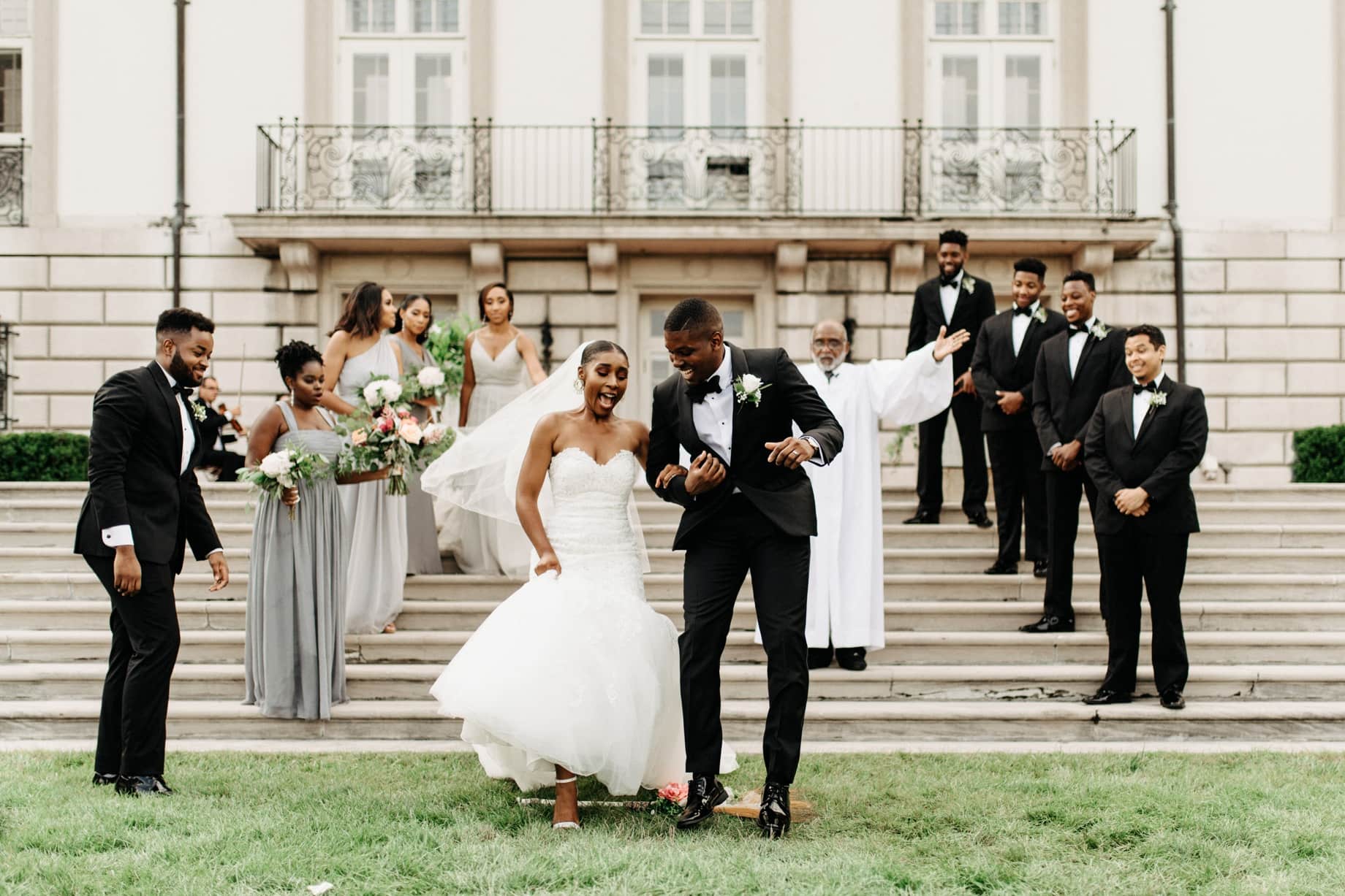 couple jumping the broom at a Gross pointe war Memorial wedding