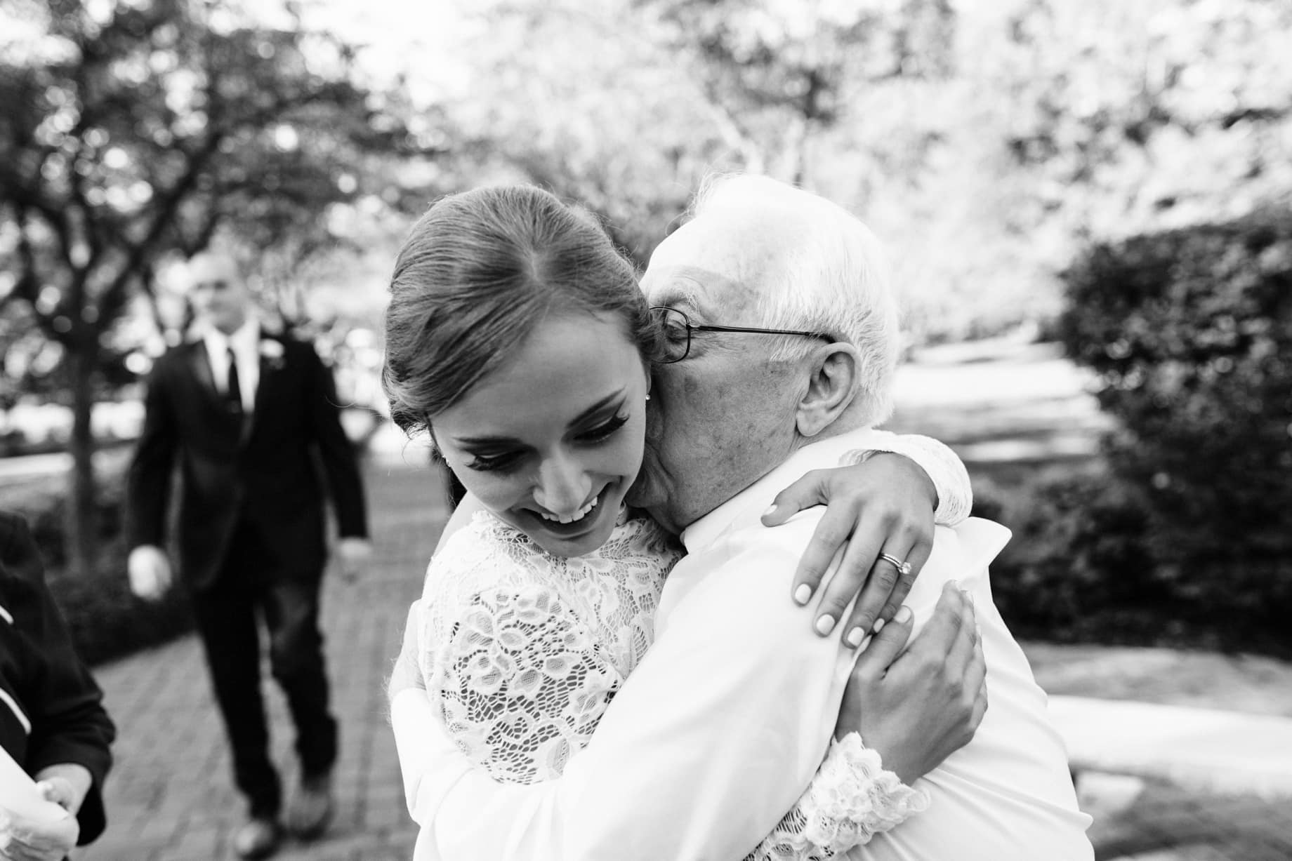 bride being embraced by her grandfather