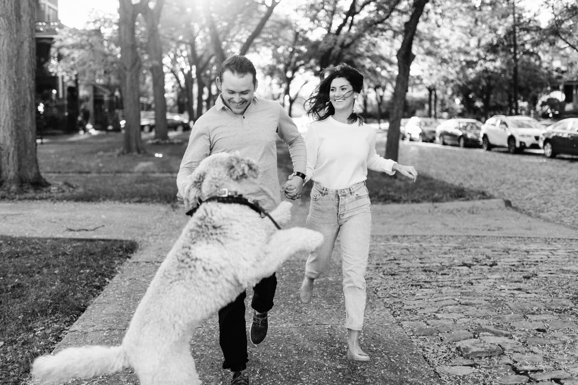 couple with their dog by detroit engagement session photographer Heather Jowett