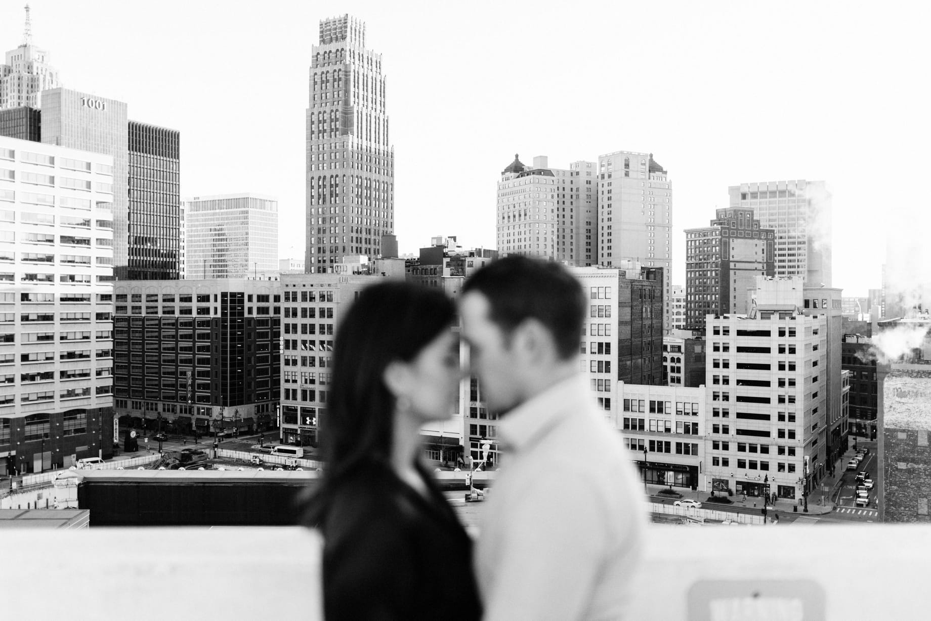couple with the detroit skyline behind them