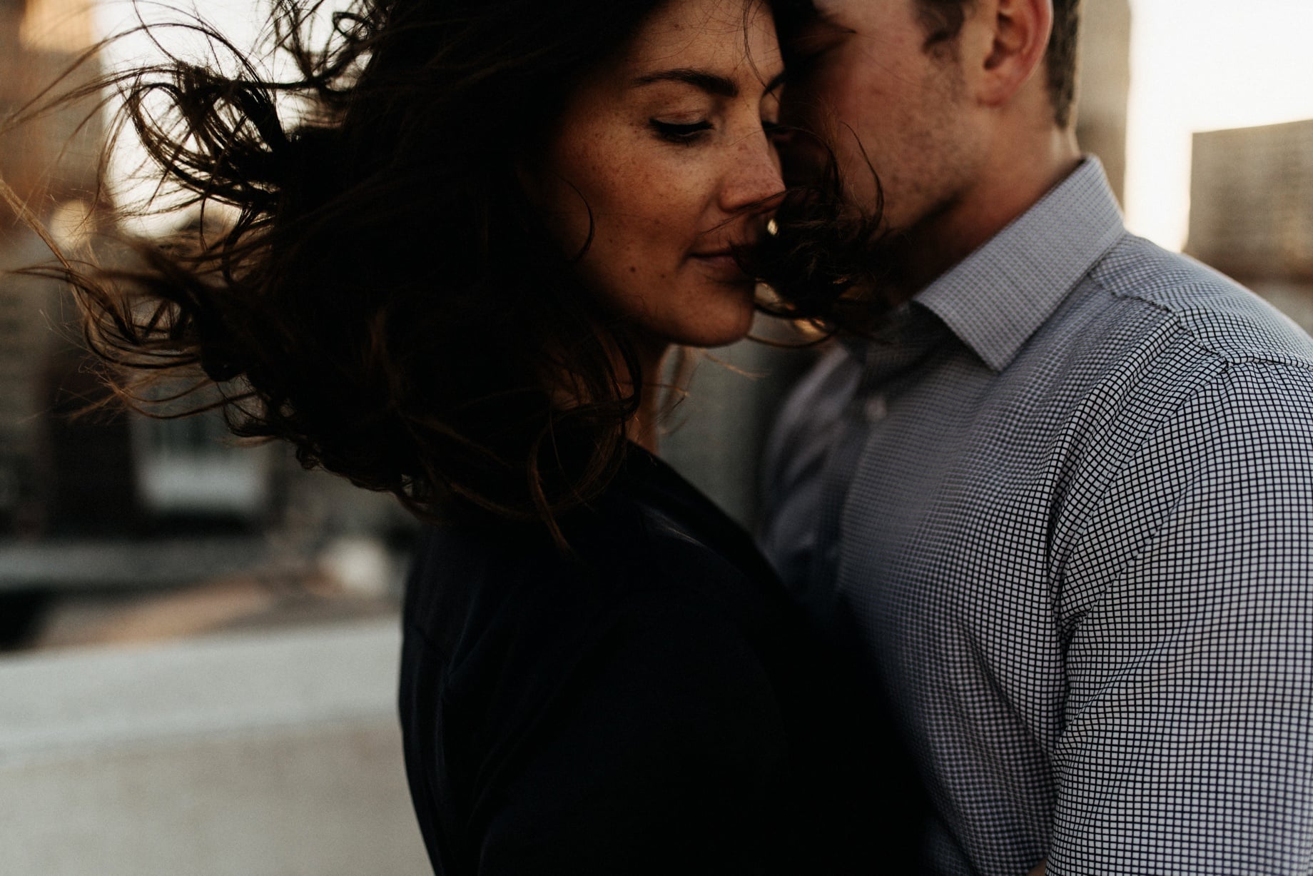 wind blowing in hair at a detroit engagement session