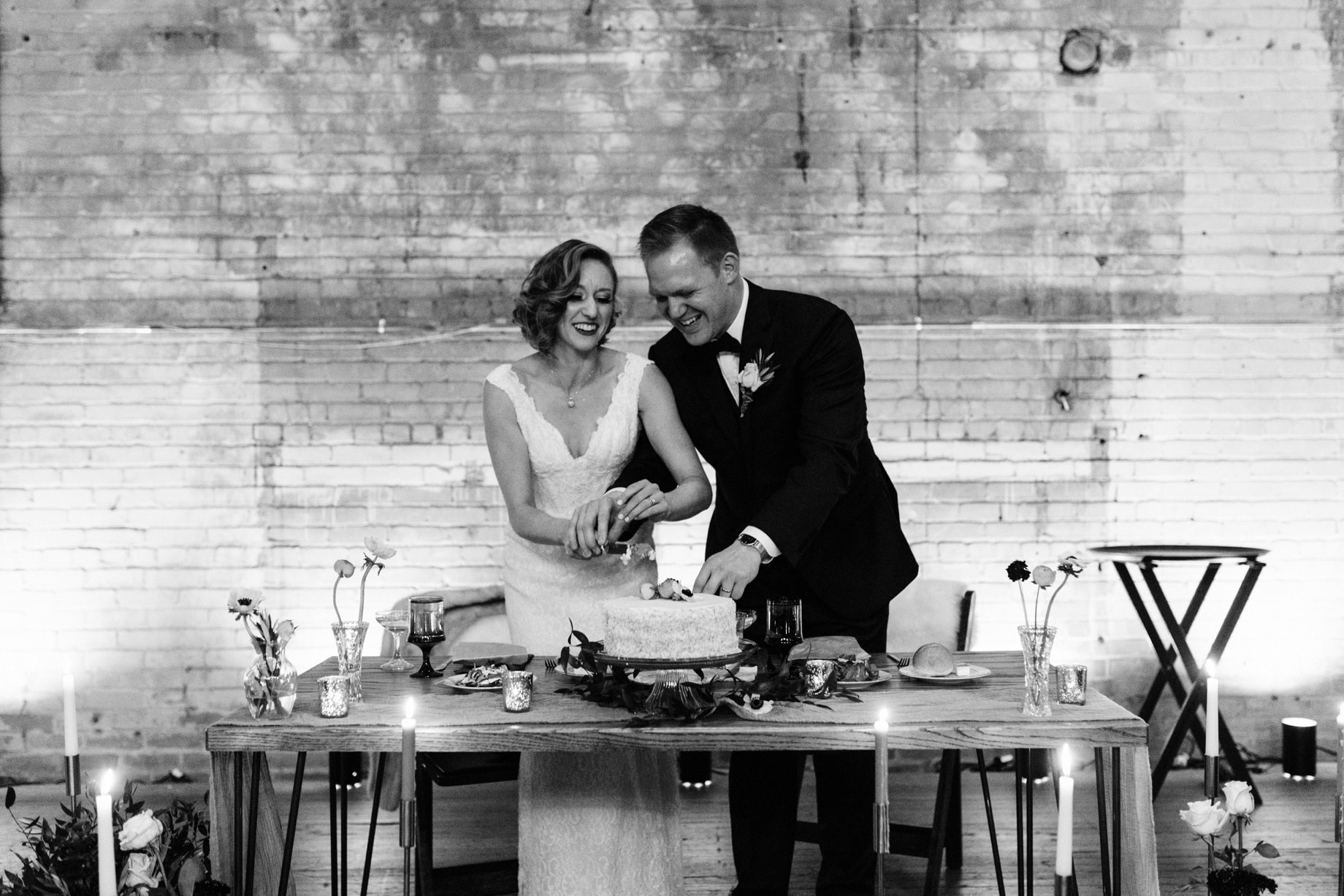 bride and groom cutting the cake at their wedding reception at the Jam Handy