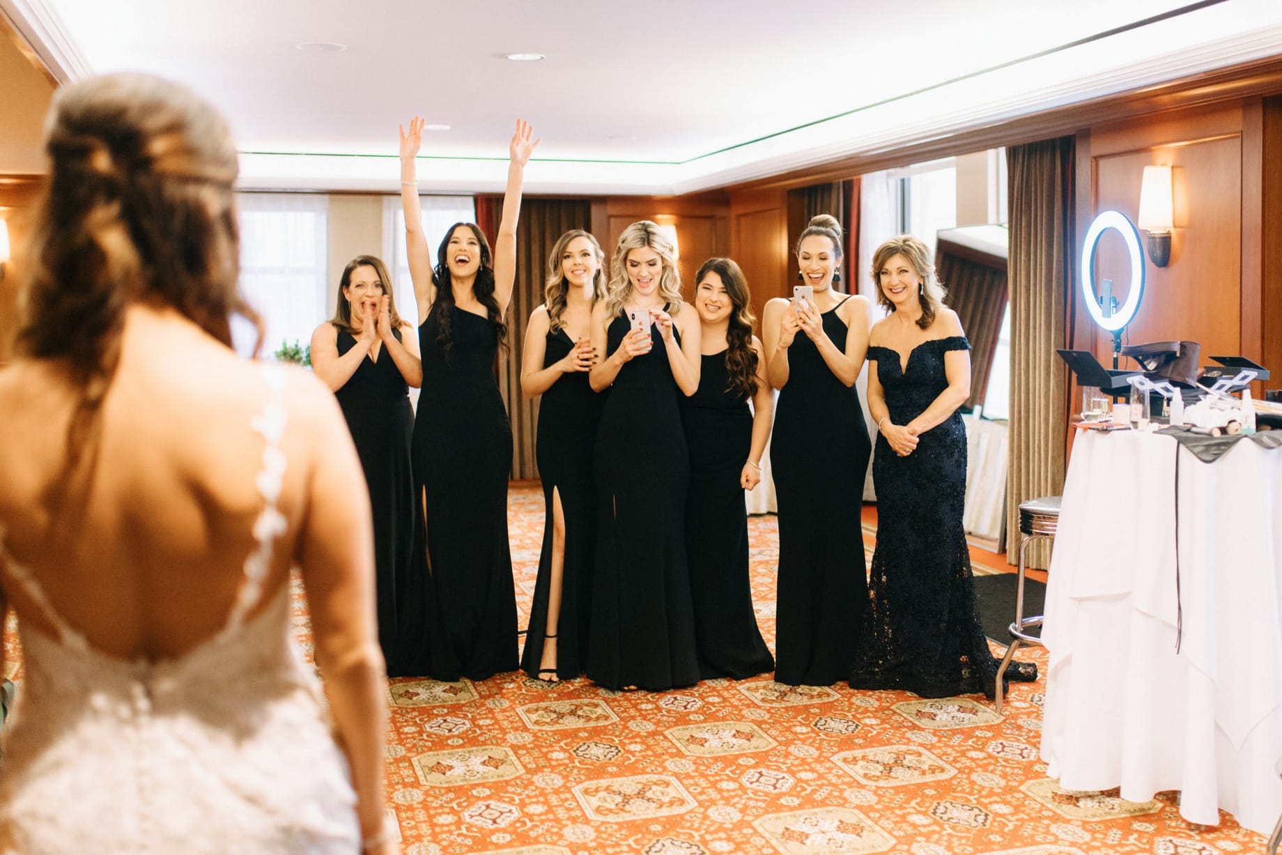 bridemaids excited to see bride in her dress