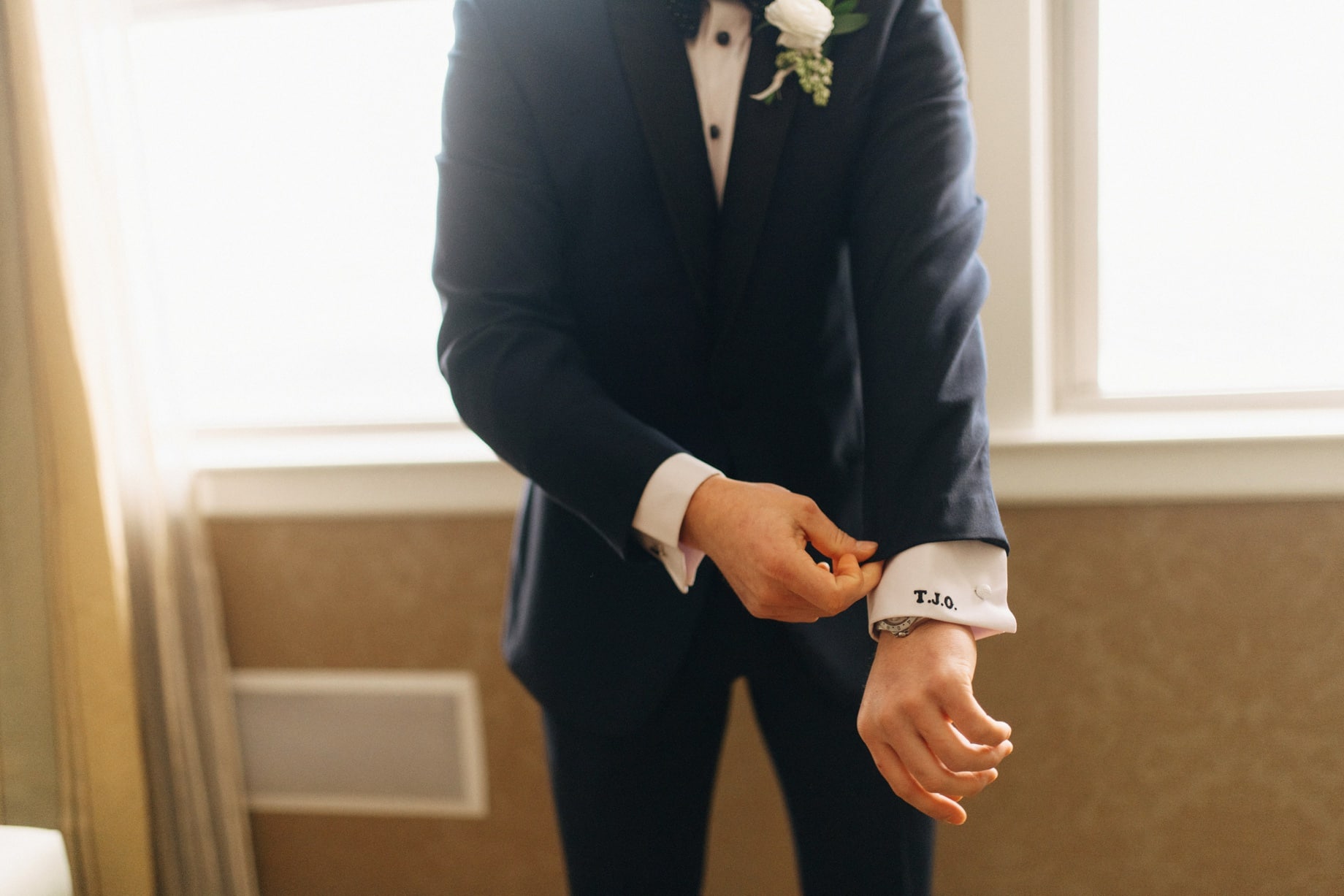 groom with custom embroidery on cuffs