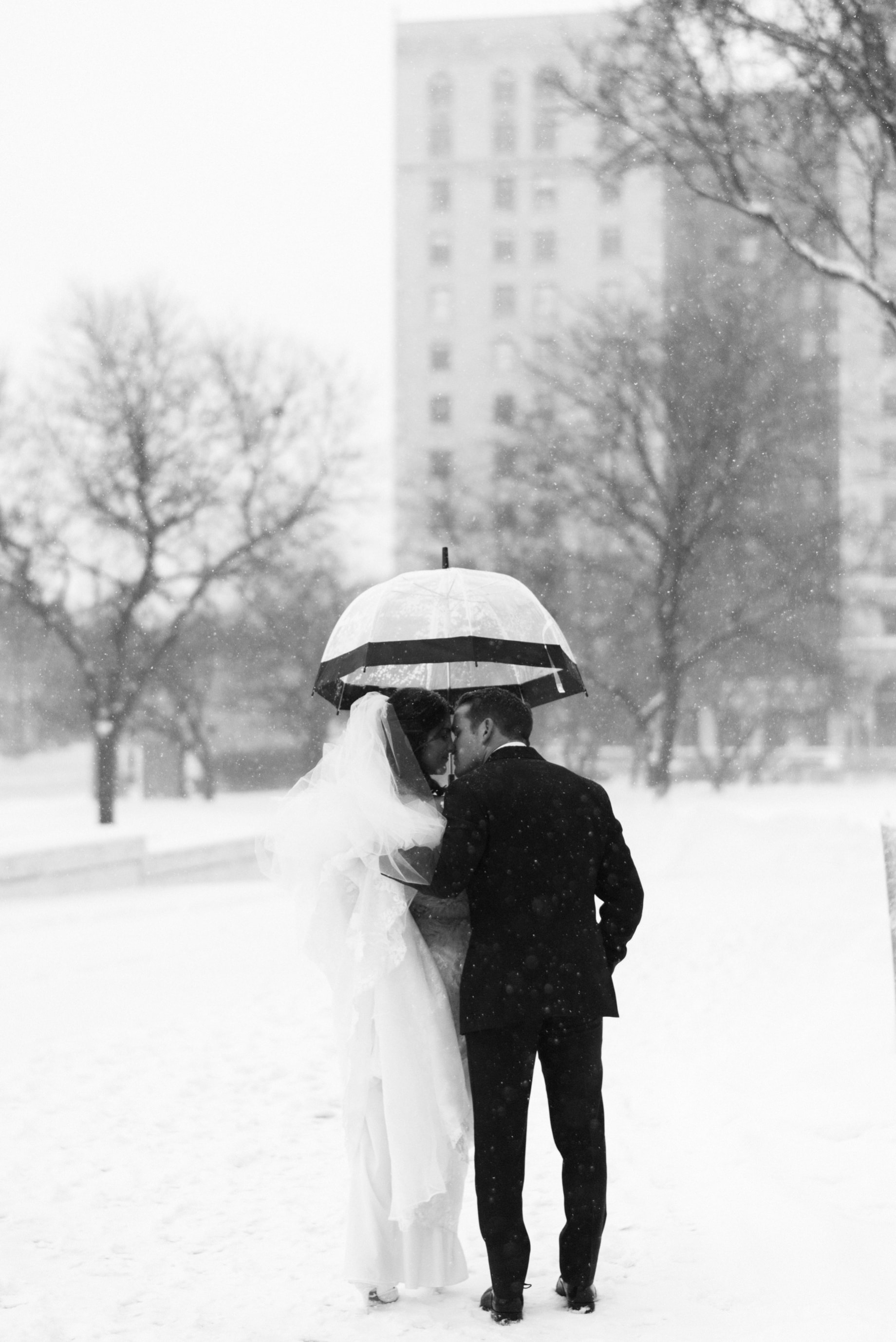 bride and groom posing in the show by Detroit wedding photographer Heather Jowett