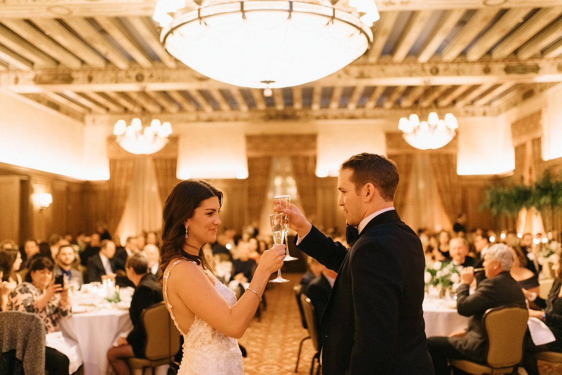 bride and groom toast their guests and one another
