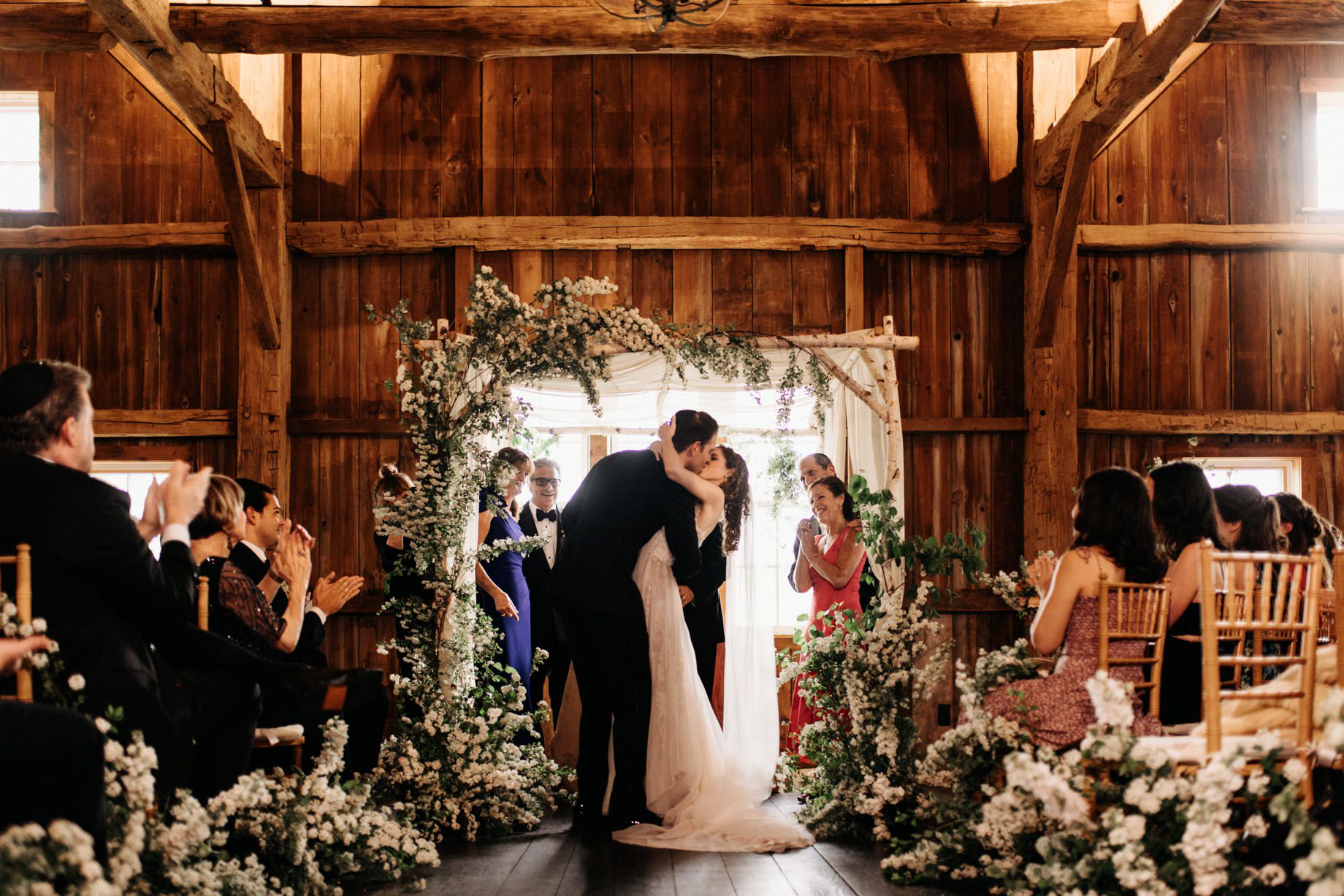 bride and groom share first kiss