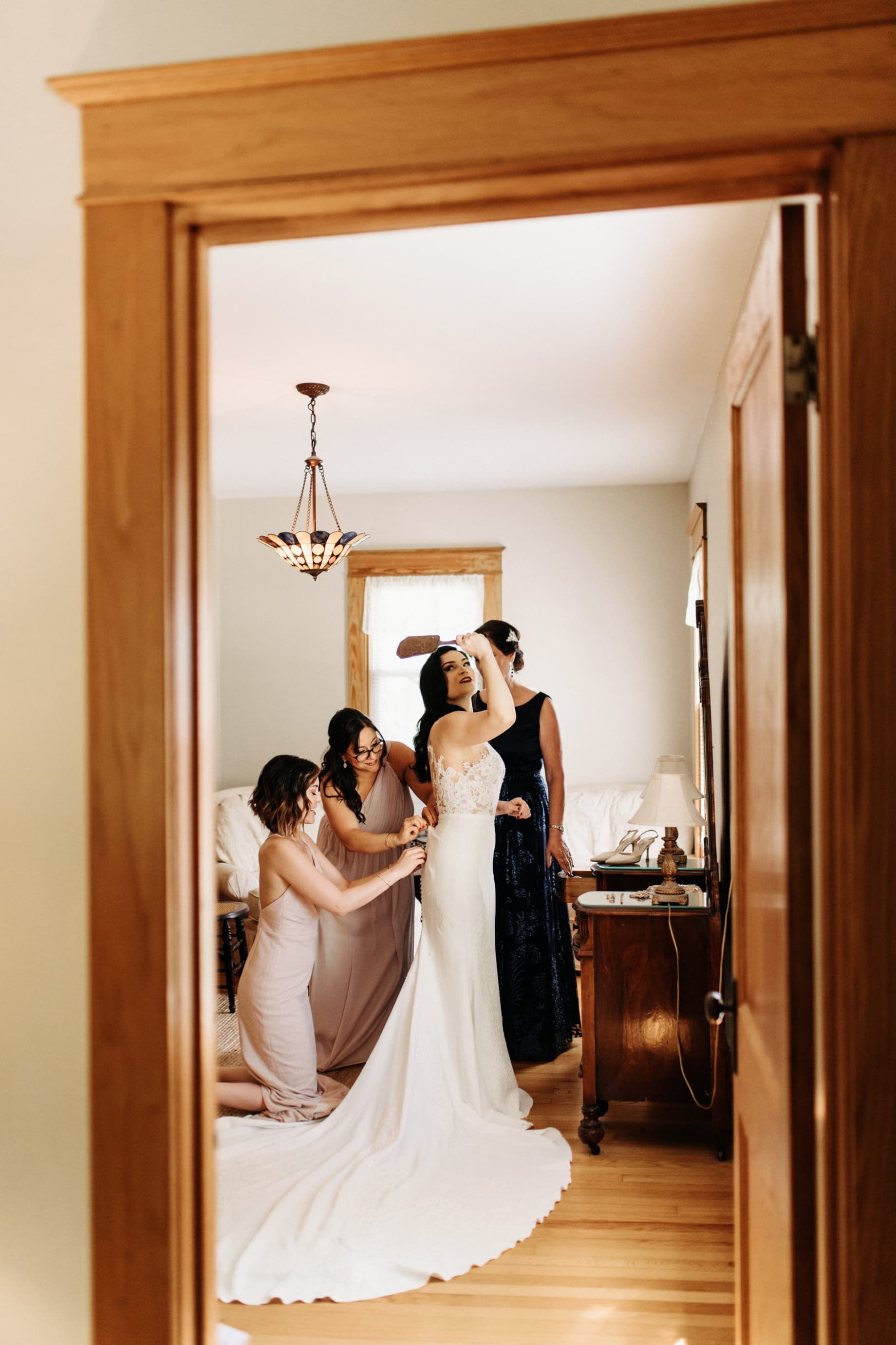 Bride getting into wedding dress at the wellers hospitality house