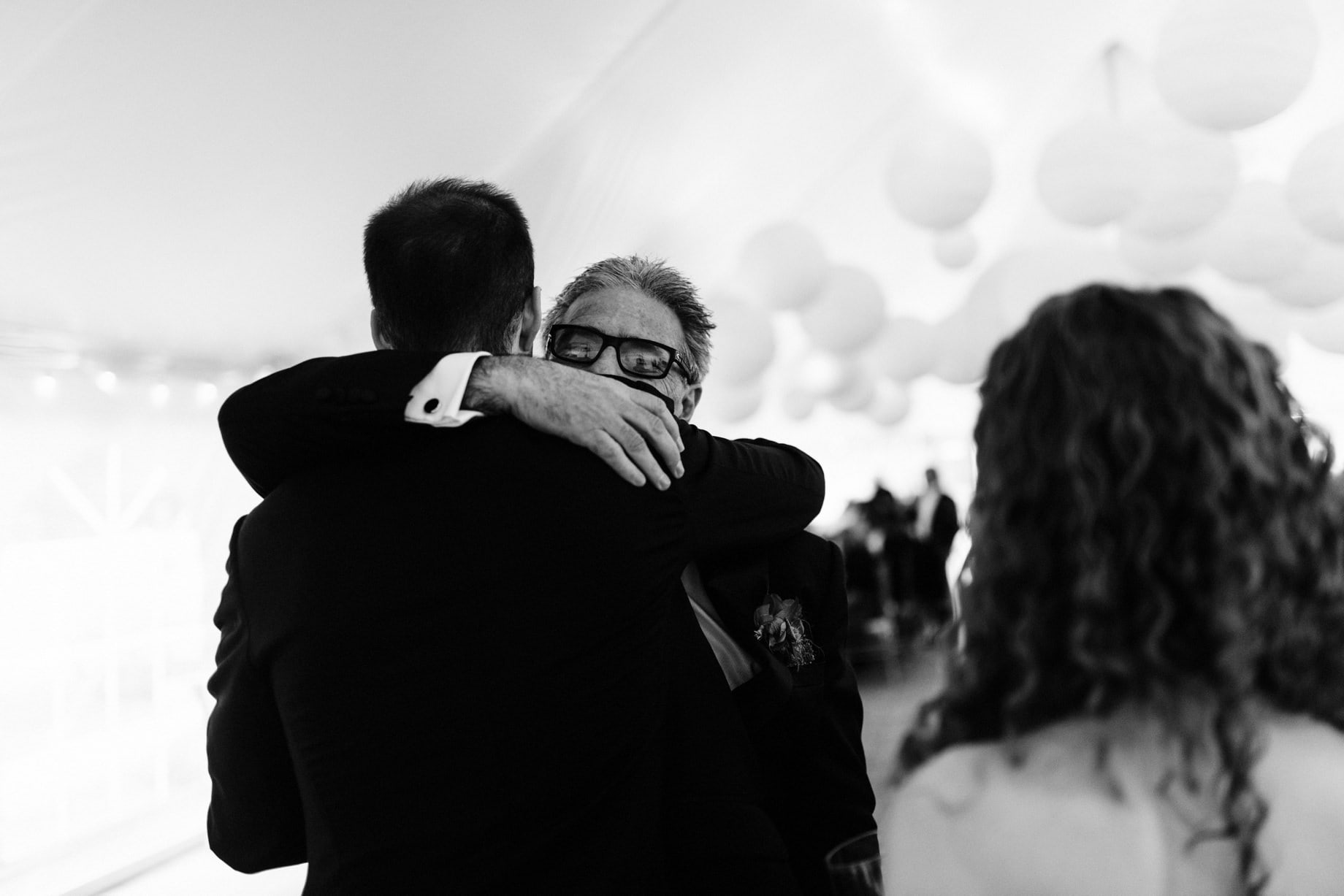 groom hugging his father