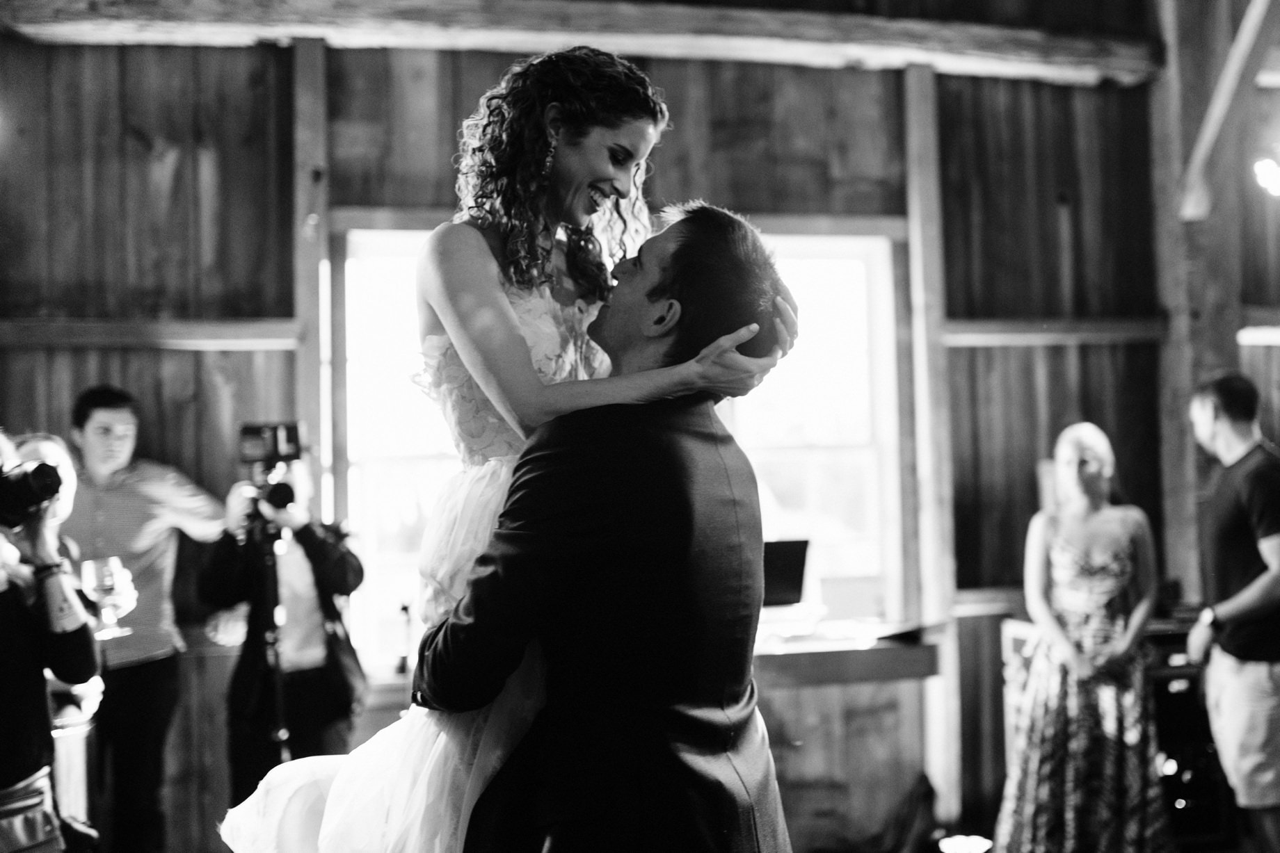 groom lifts bride during first dance