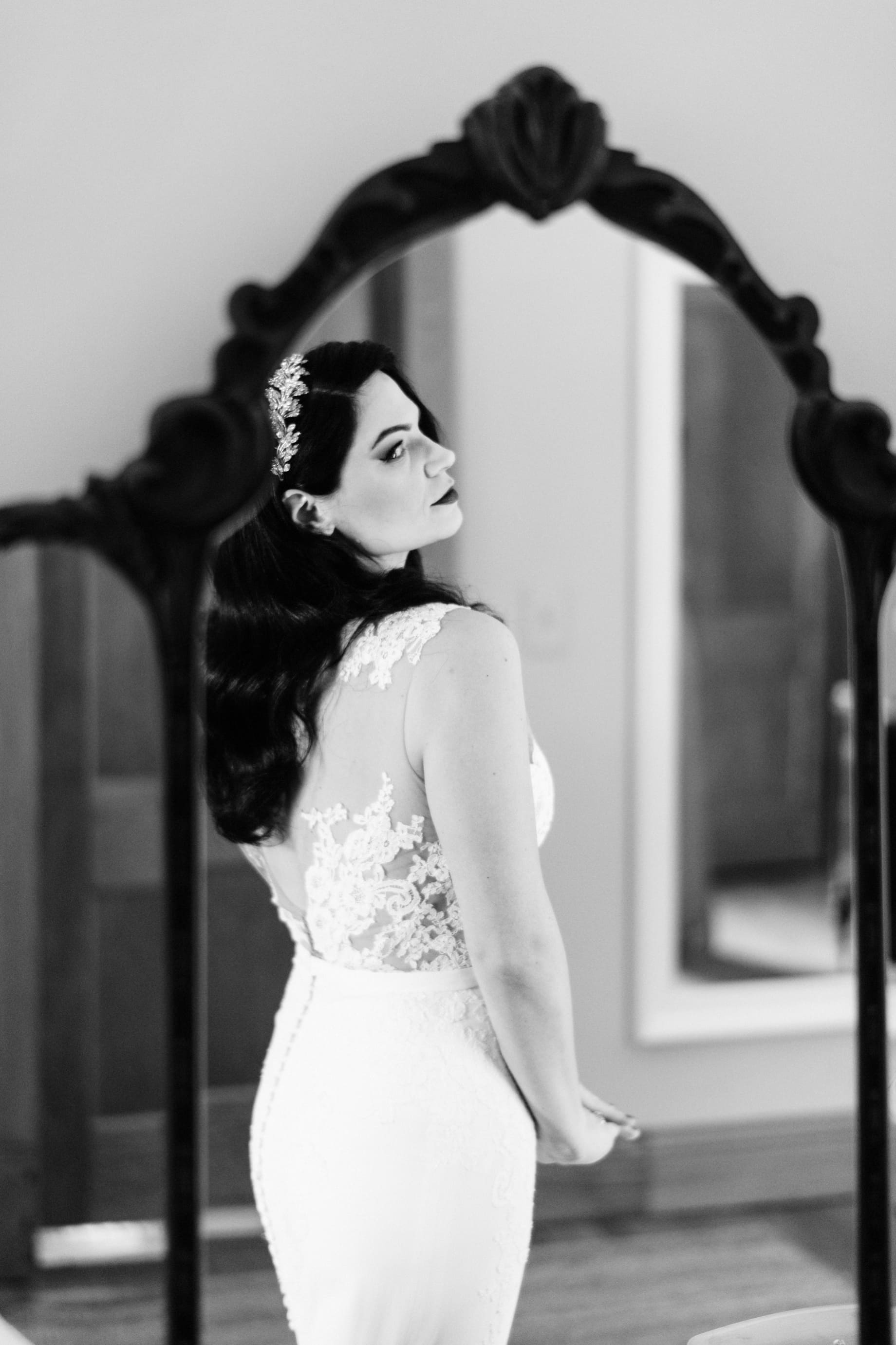 bride checking herself out in the mirror