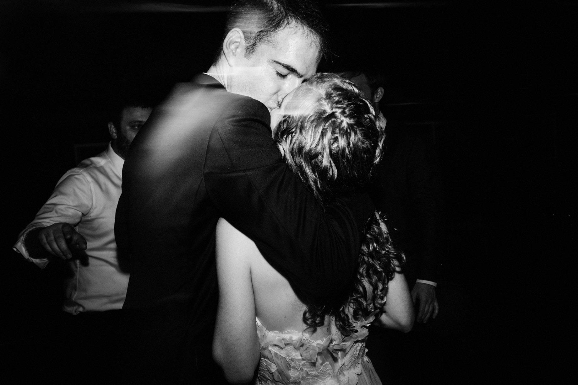 bride and groom share a kiss on the dance floor